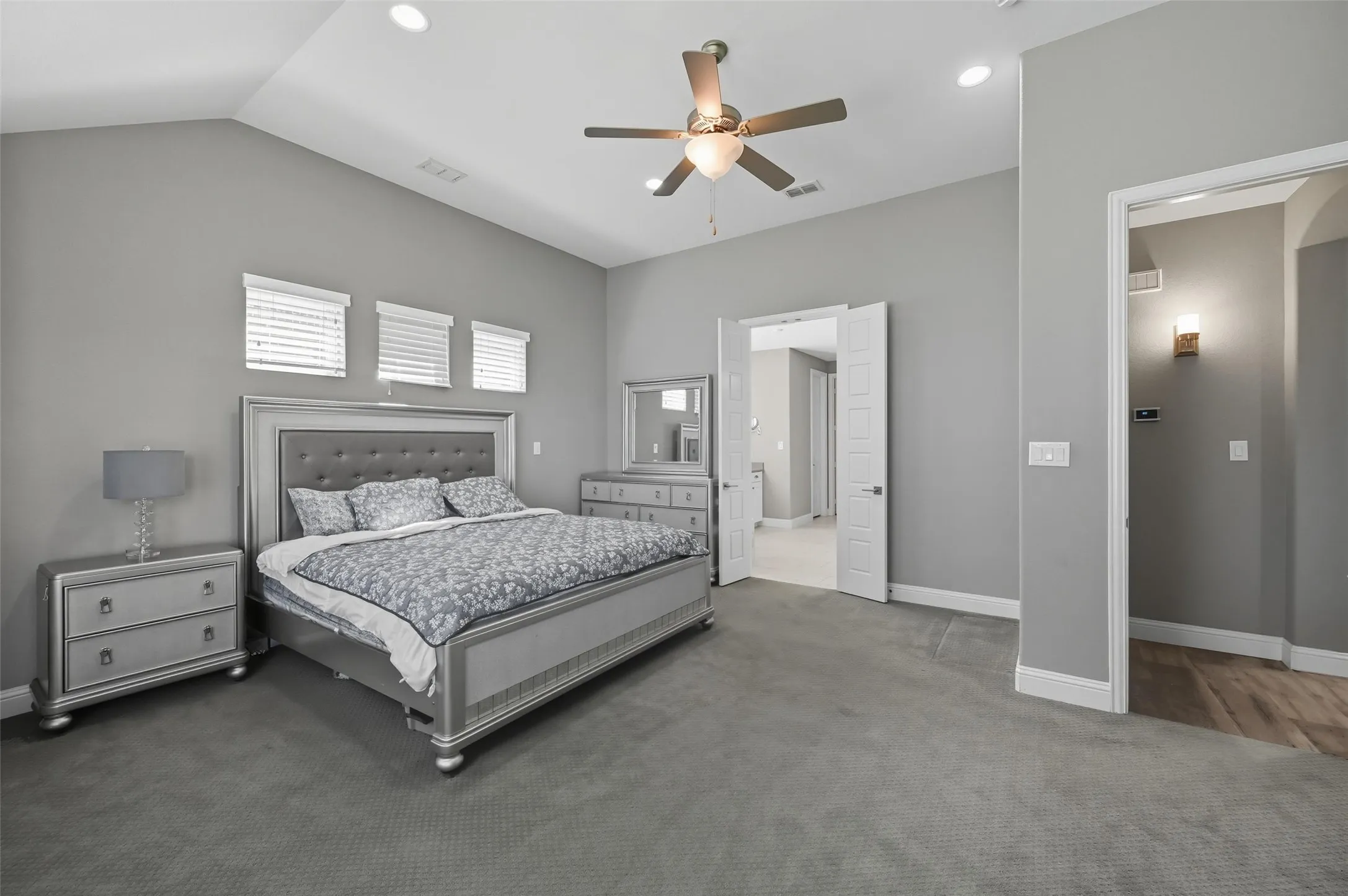 Spacious bedroom featuring vaulted ceilings, recessed lighting, ceiling fan, and carpet flooring