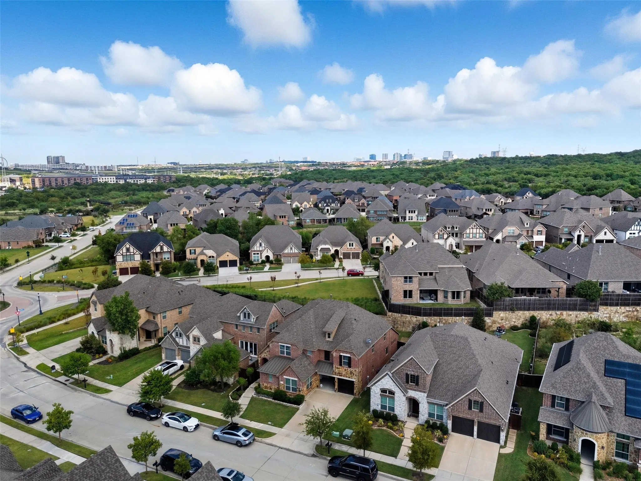 Expansive residential community featuring a variety of architectural styles, mature landscaping, and paved streets