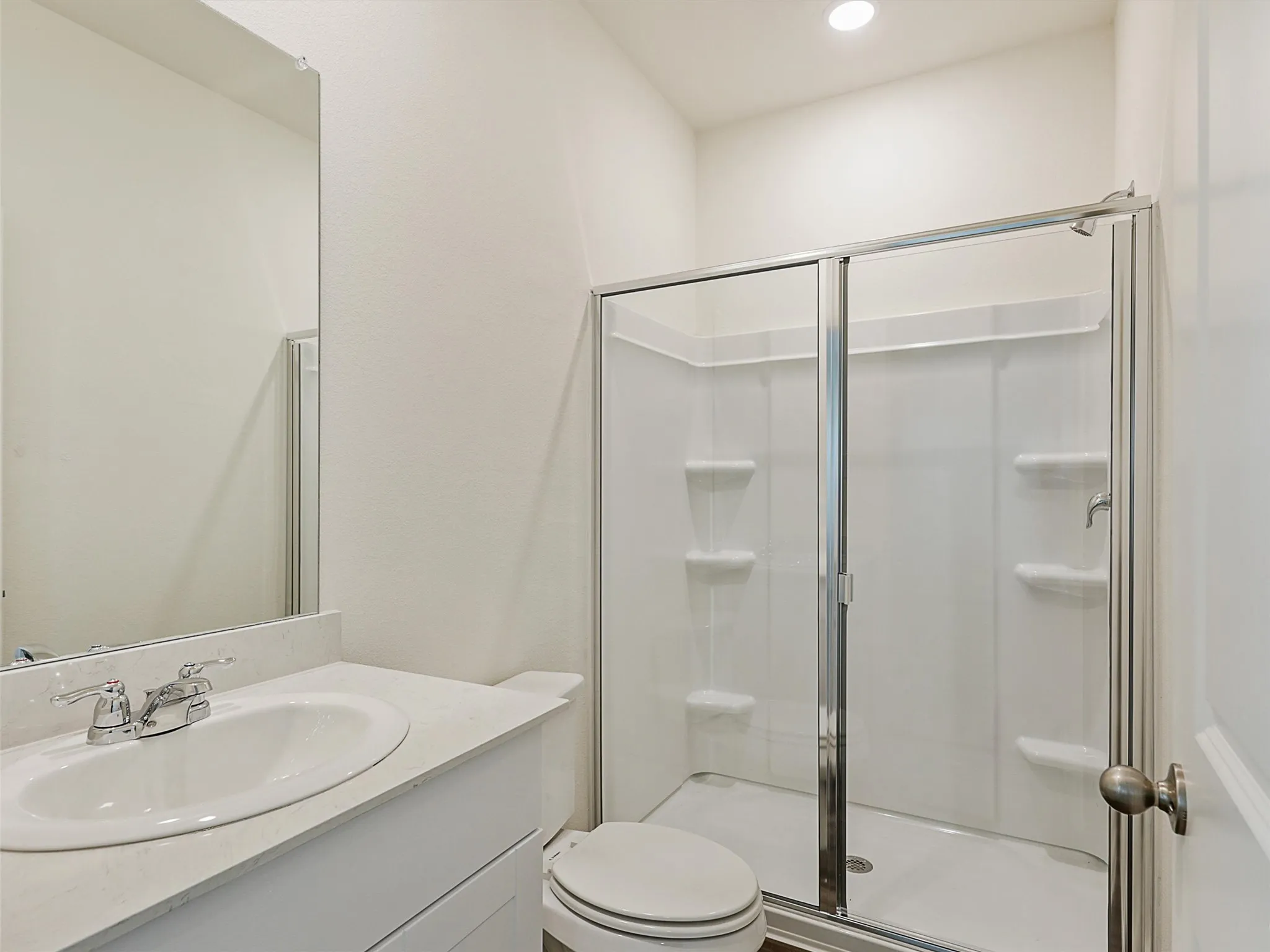 Bathroom featuring a vanity with an integrated sink and light-colored countertop