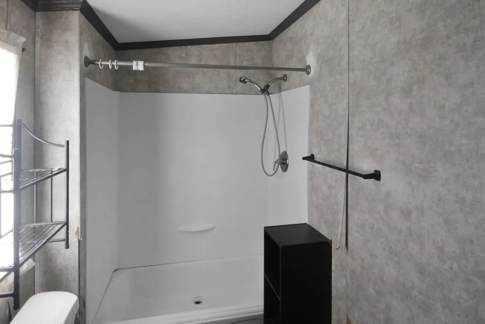 White bathtub and shower combination with a curved shower curtain rod