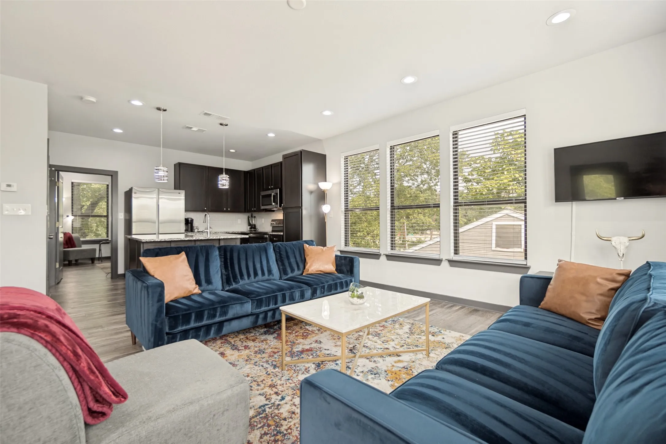 Open-concept living space featuring wood-finish flooring and recessed lighting