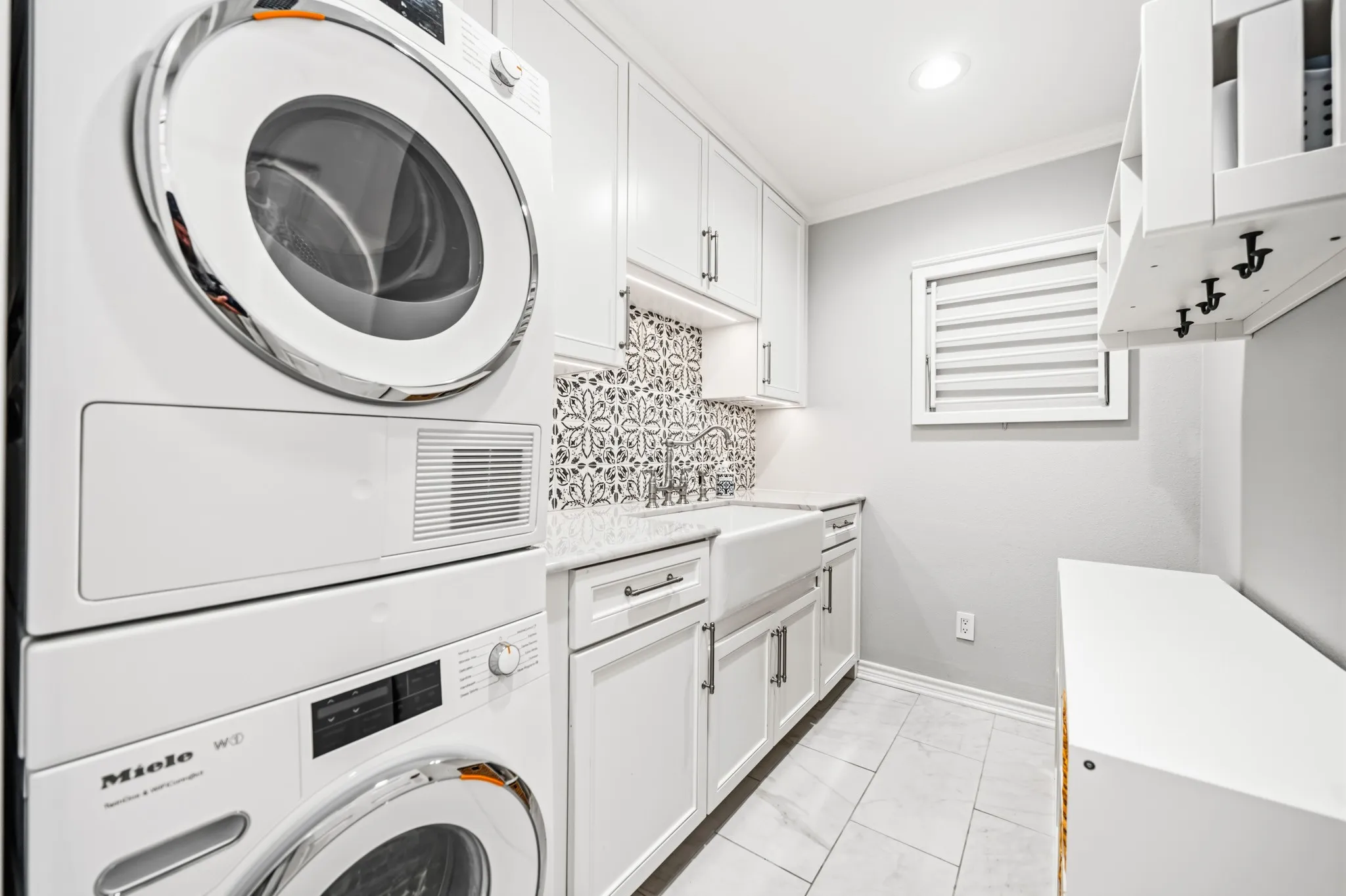Miele Washer & Dryer, decorative tile, apron sink, and built-ins