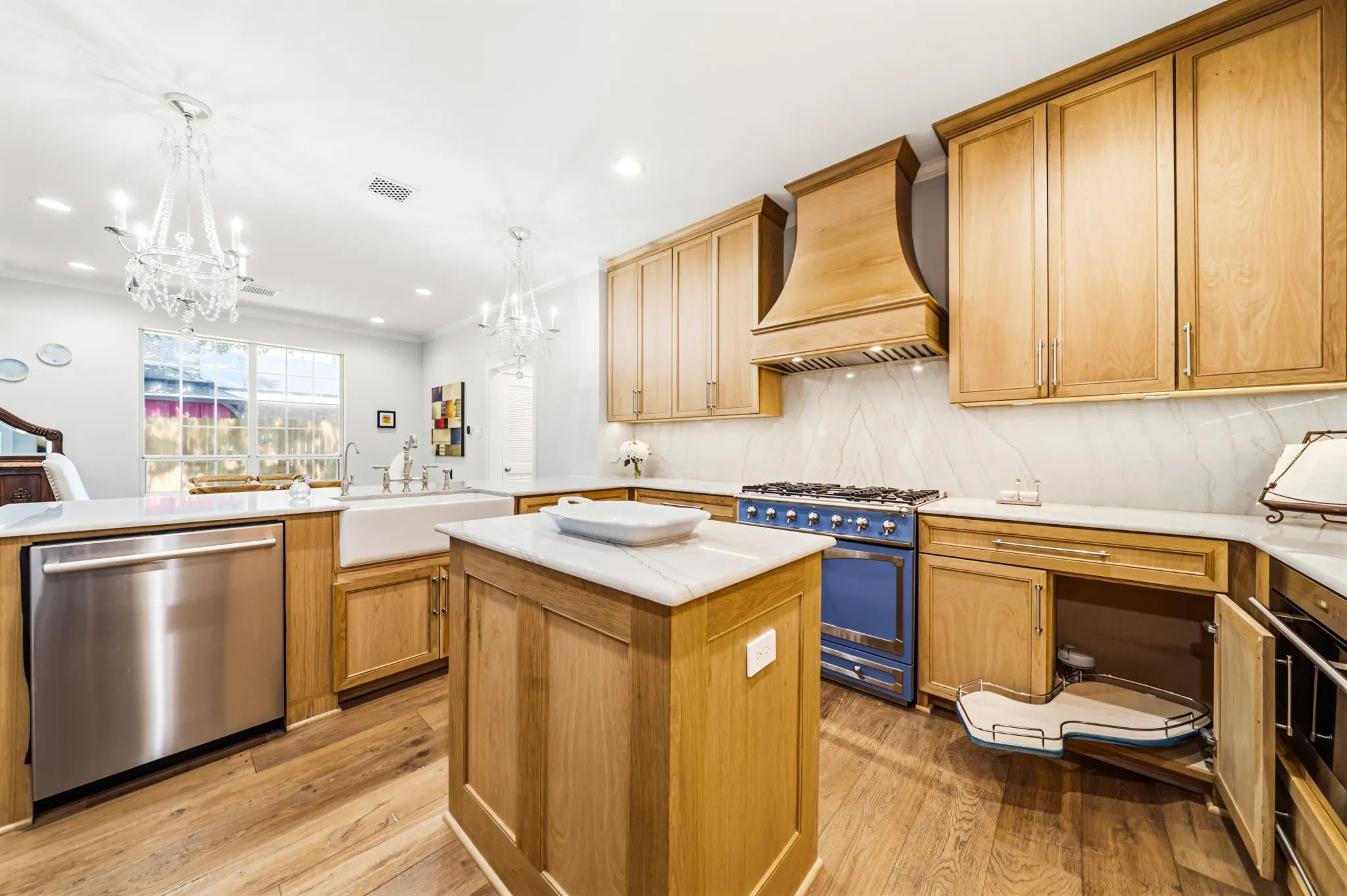 White oak cabinetry, porcelain farm sink, Bosch dishwasher, work island