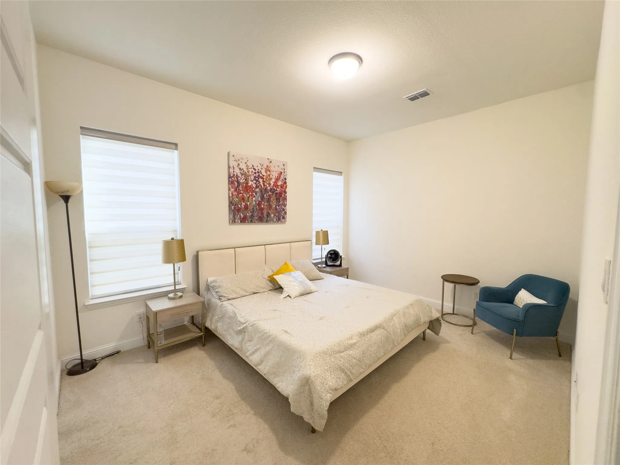 Recessed lighting, plush carpet flooring, and multiple windows with blinds