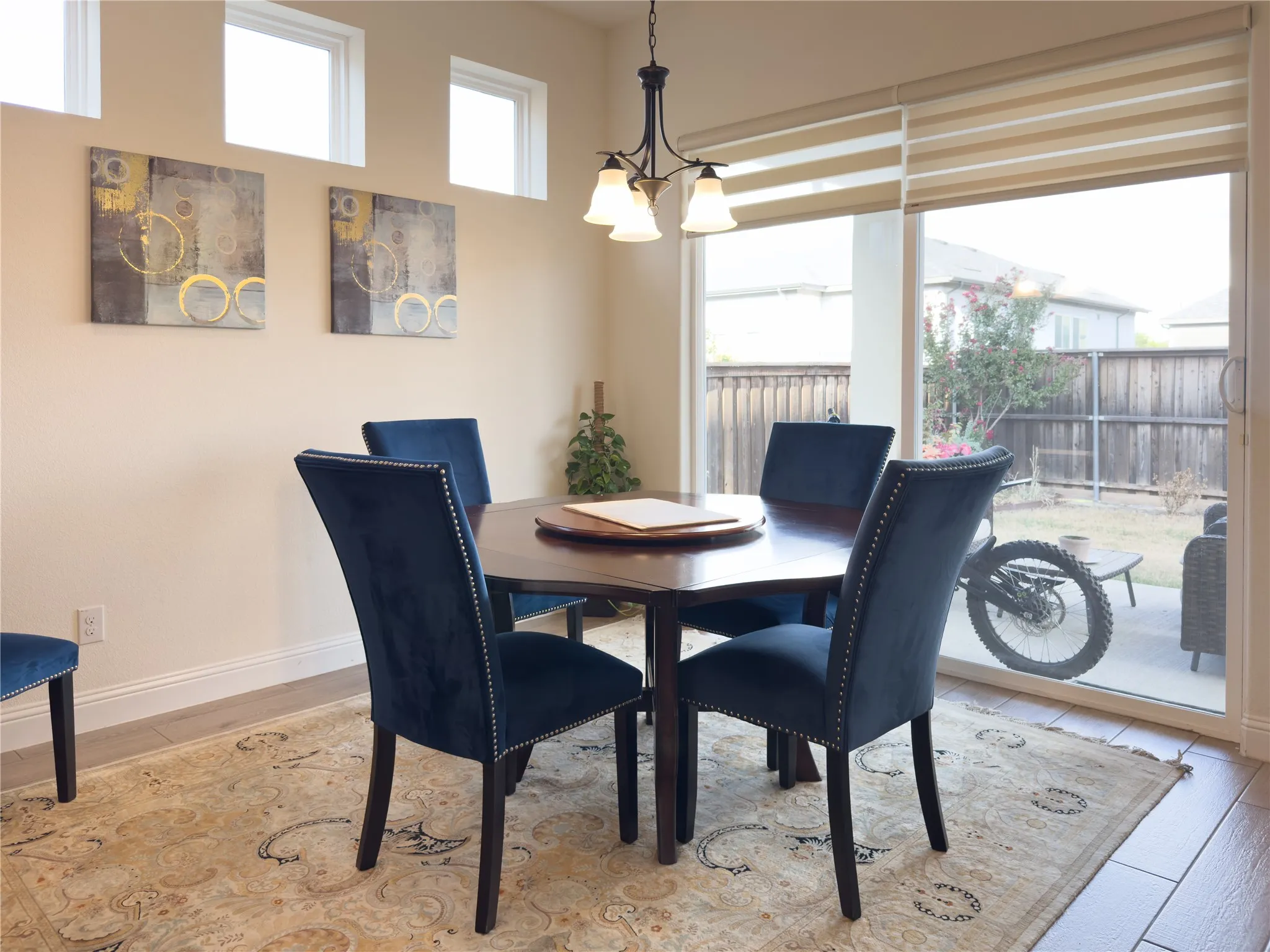 Hardwood-style flooring, transom windows, sliding glass door, and a built-in chandelier