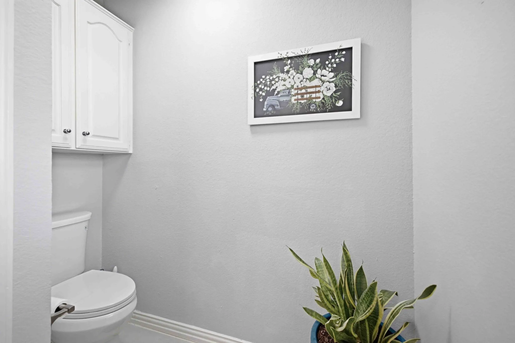 White cabinet storage with decorative hardware