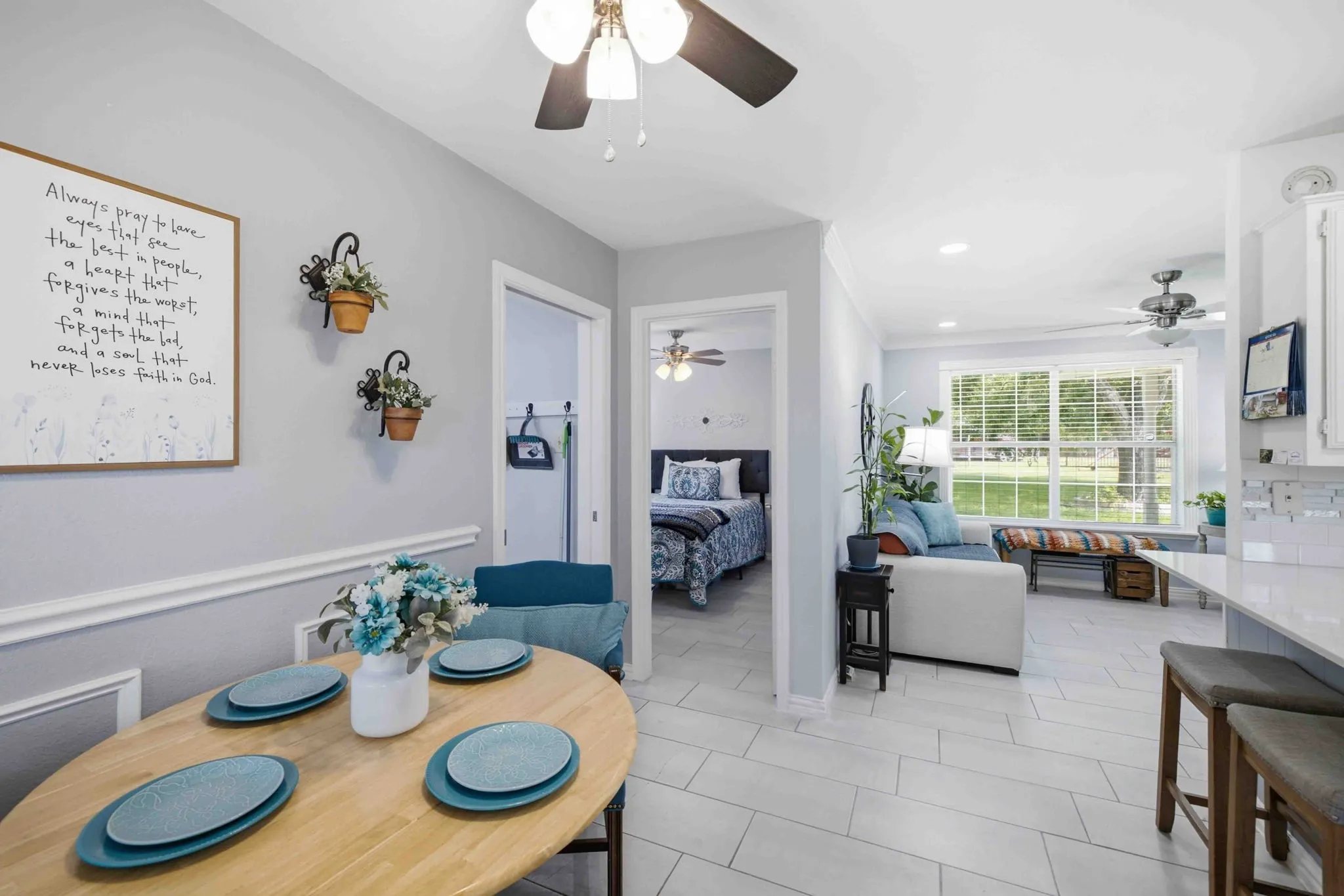 Light gray wall paint, white trim, tile flooring, built-in ceiling lighting, and ceiling fans