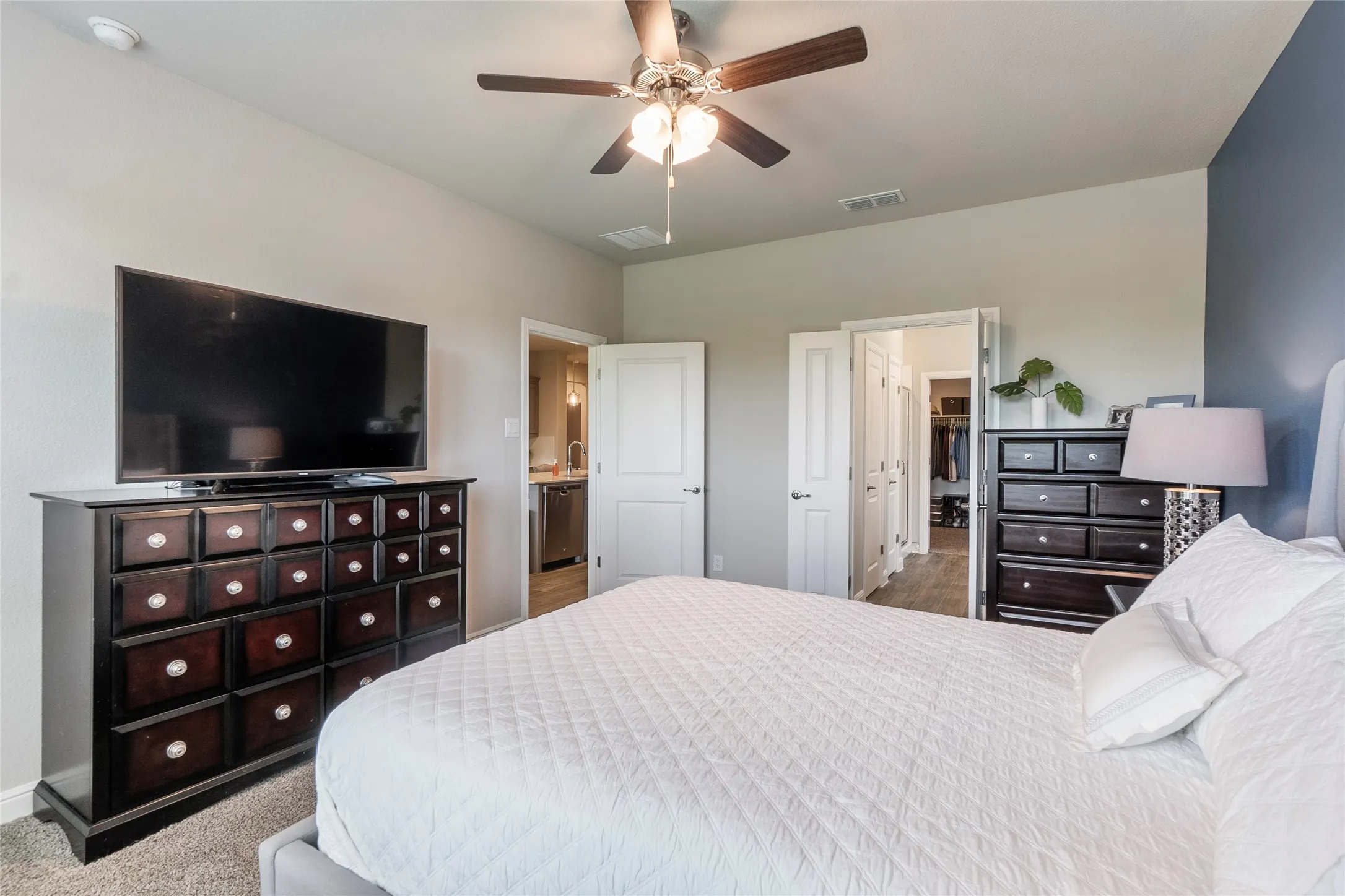 King size bed & furniture easily fit in this primary bedroom