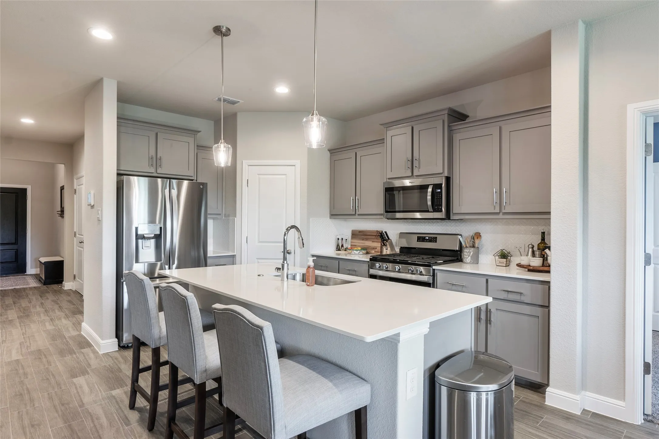 Stainless steel appliances & pendant lights