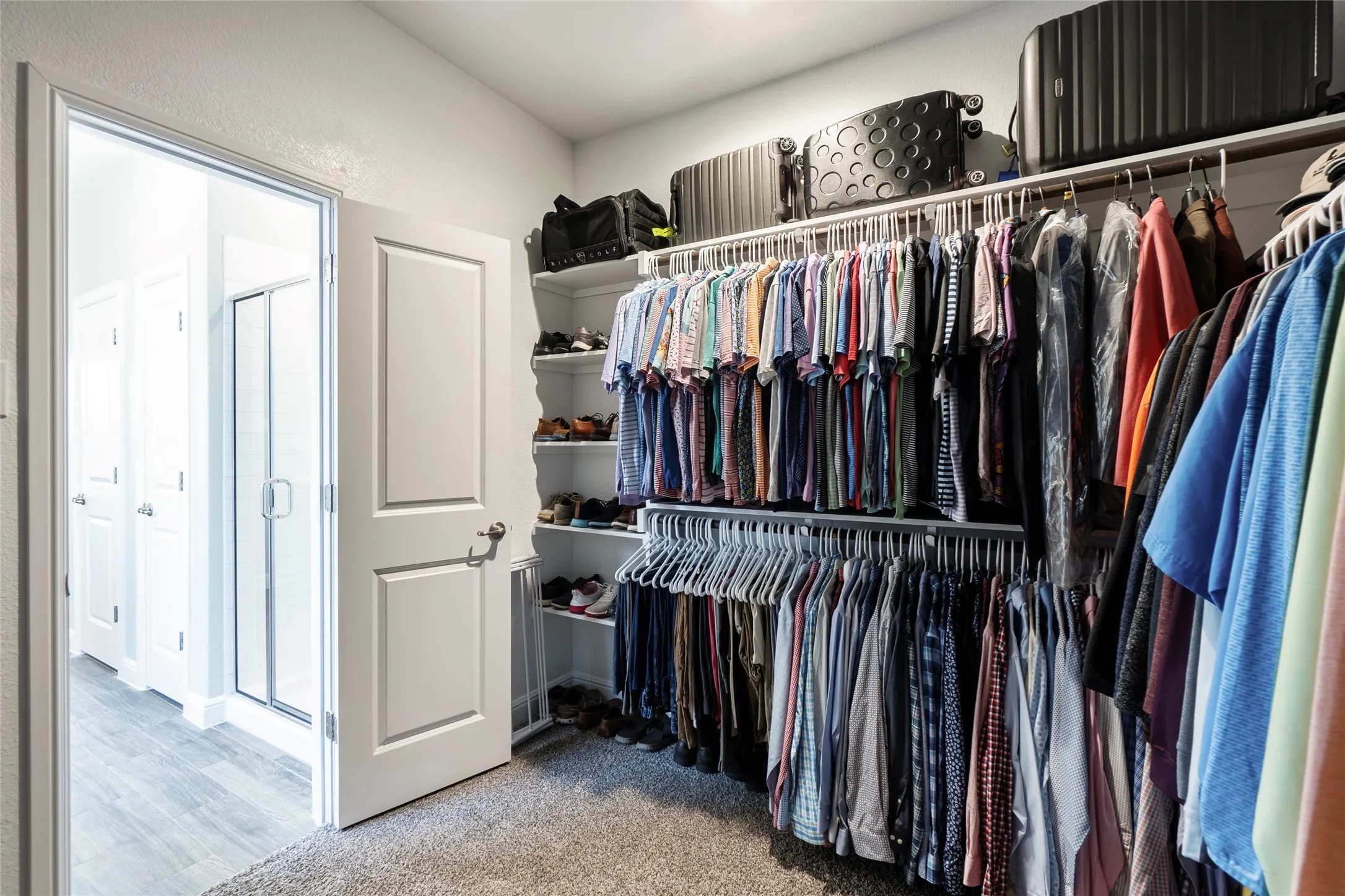 Primary closet offers tons of storage & shelves