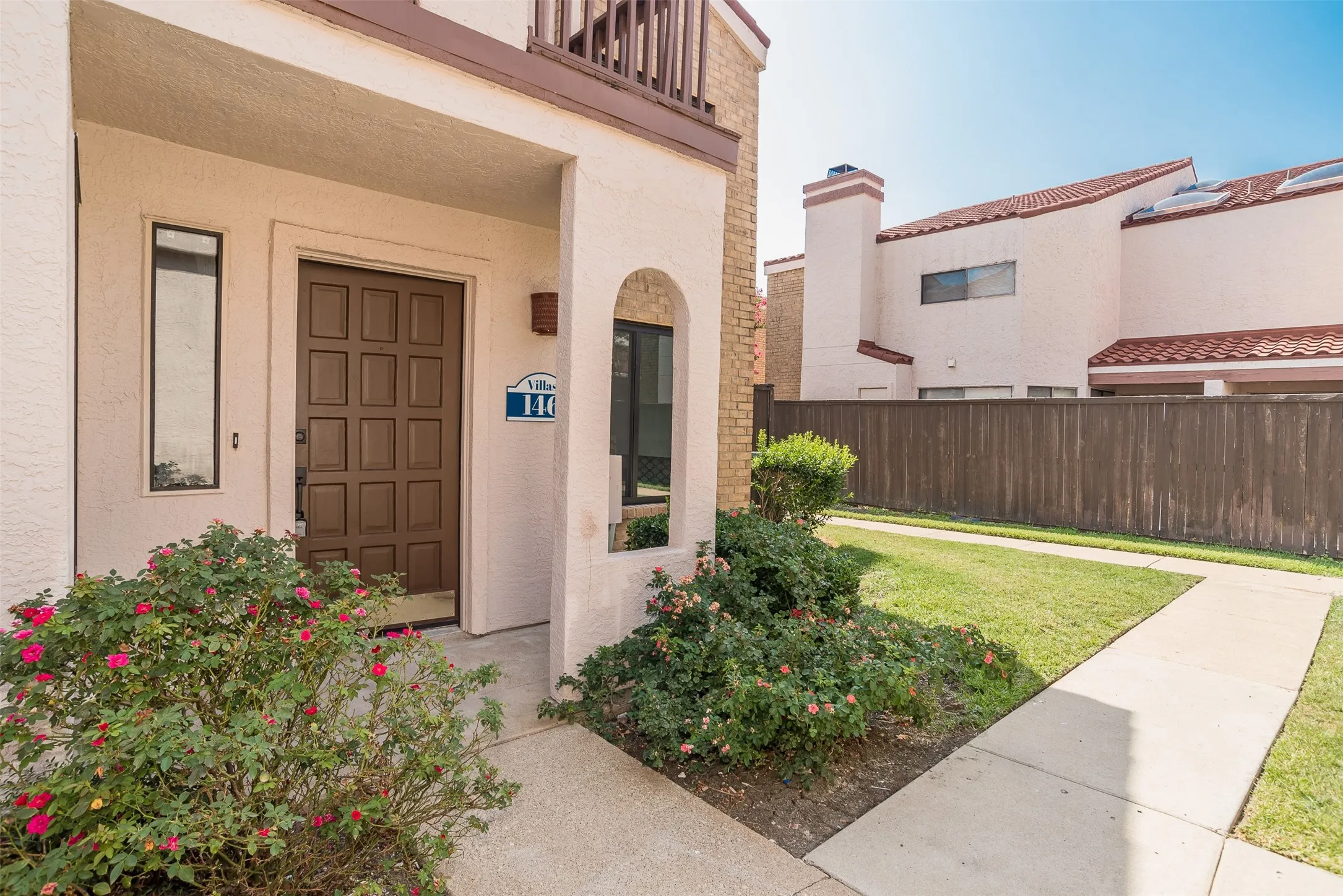 Entryway featuring a paneled door, vertical window, and an arched window