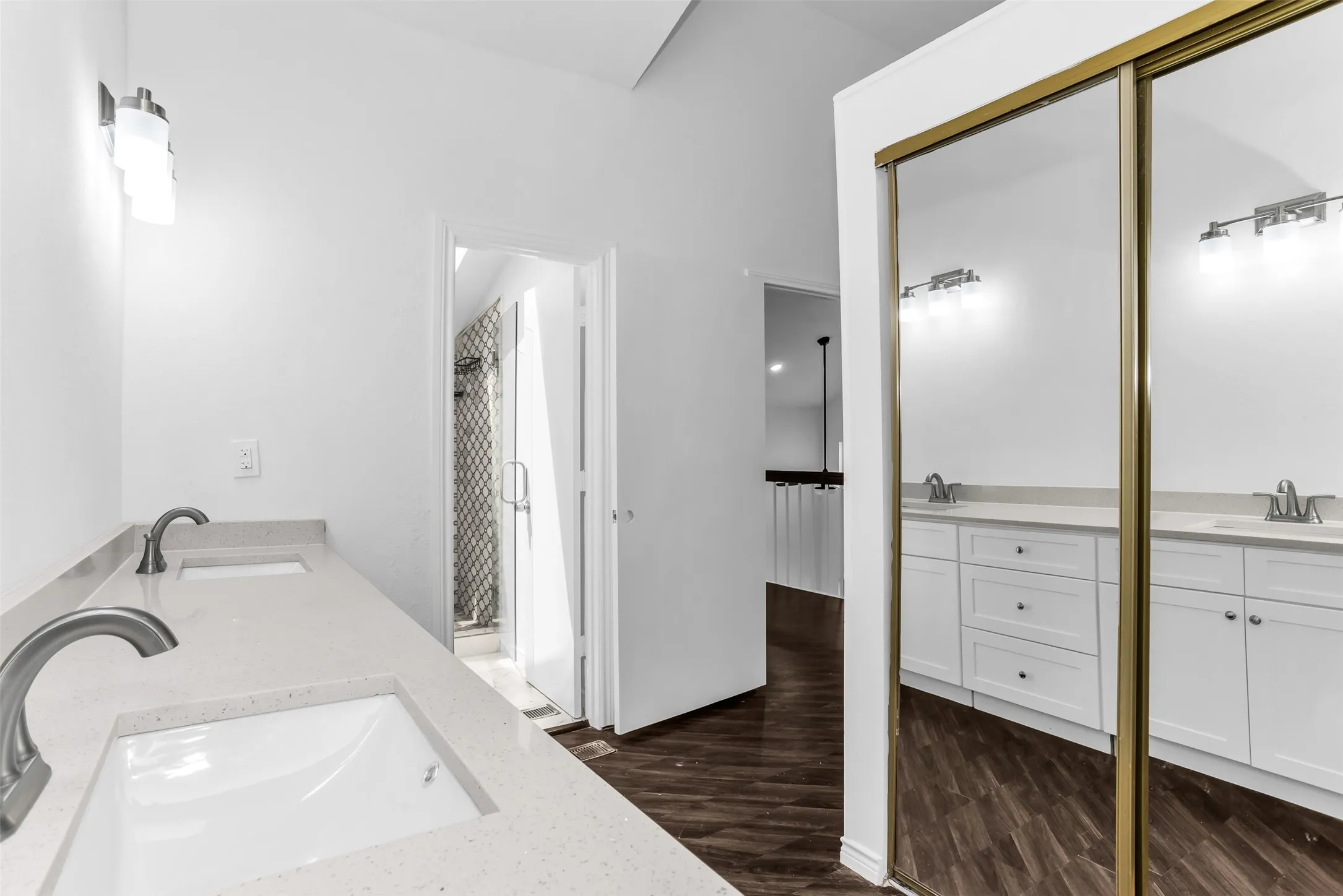 Dual vanity with undermount sinks, stone countertops, and brushed nickel fixtures