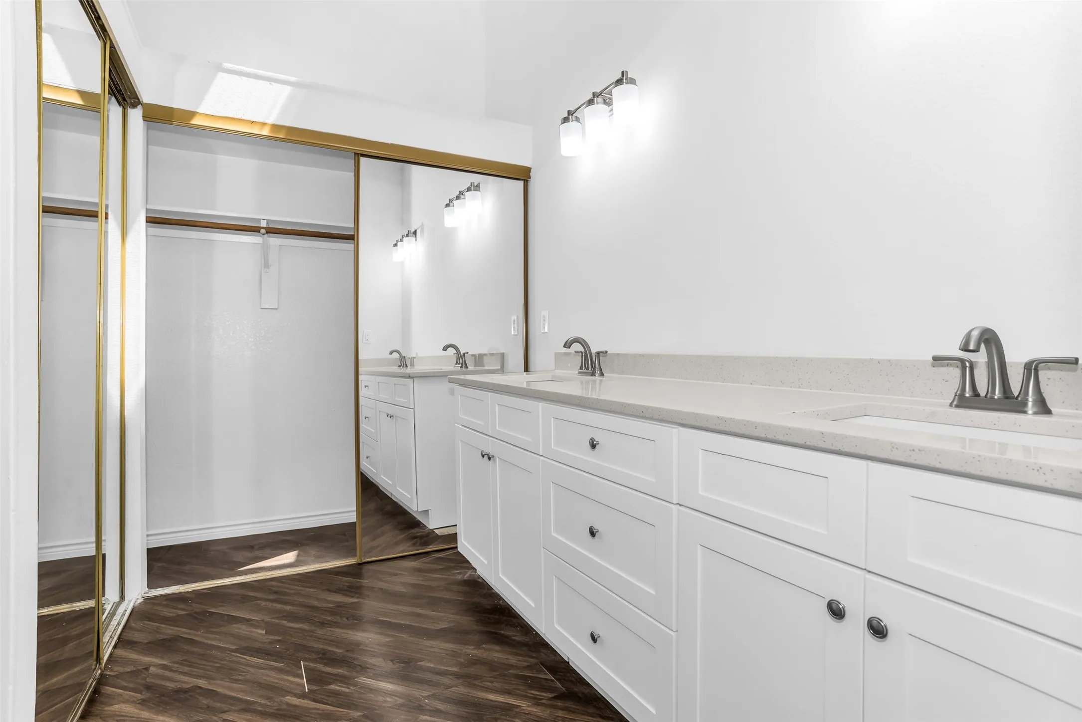 Dual vanity with quartz countertops, undermount sinks, and brushed nickel fixtures