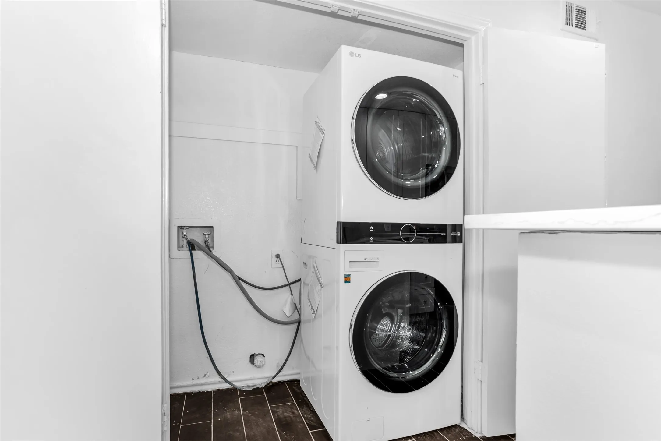 Stackable laundry machines with wood-finish flooring