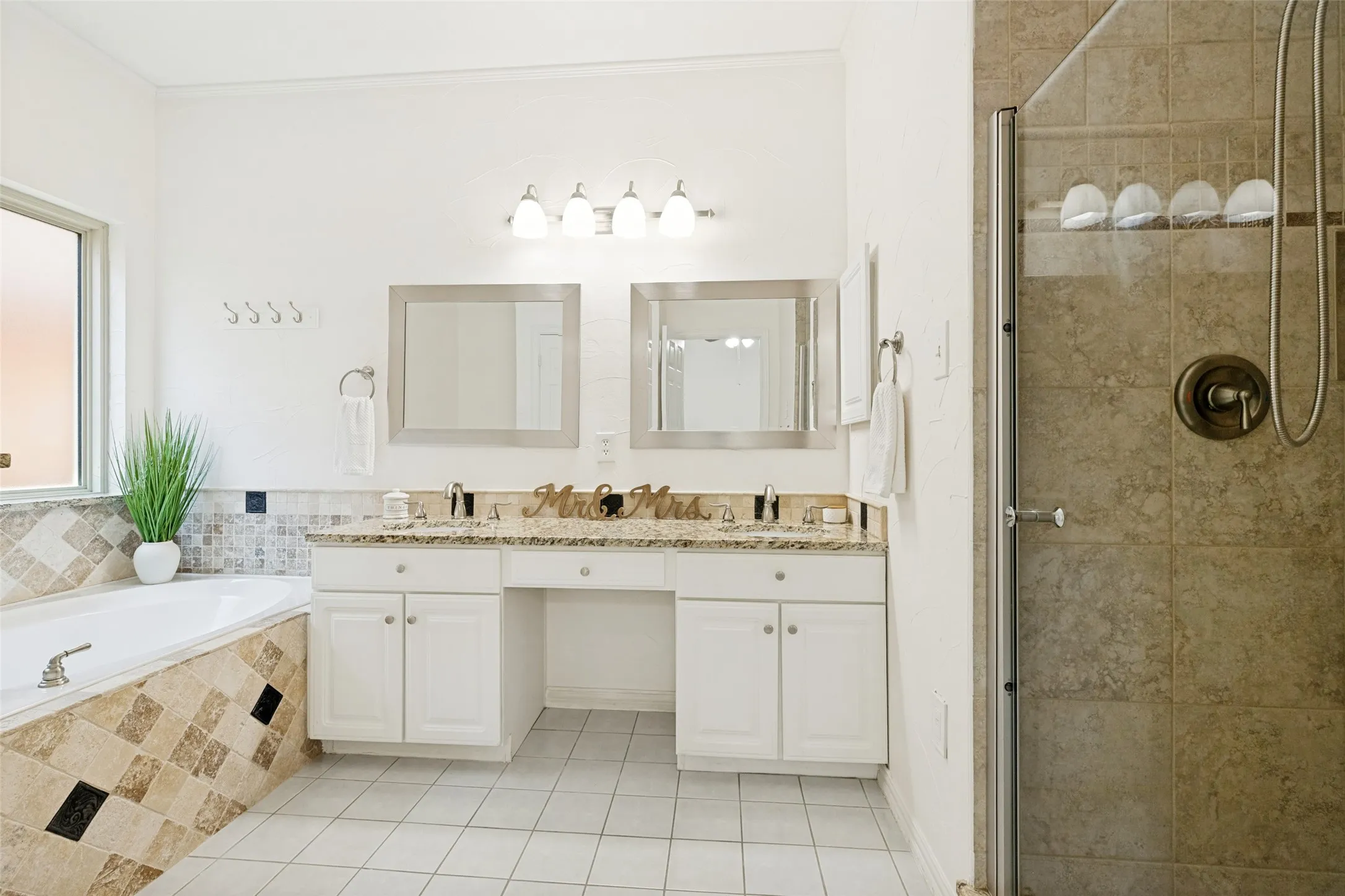 Primary Bathroom with Tub and Dual Sinks