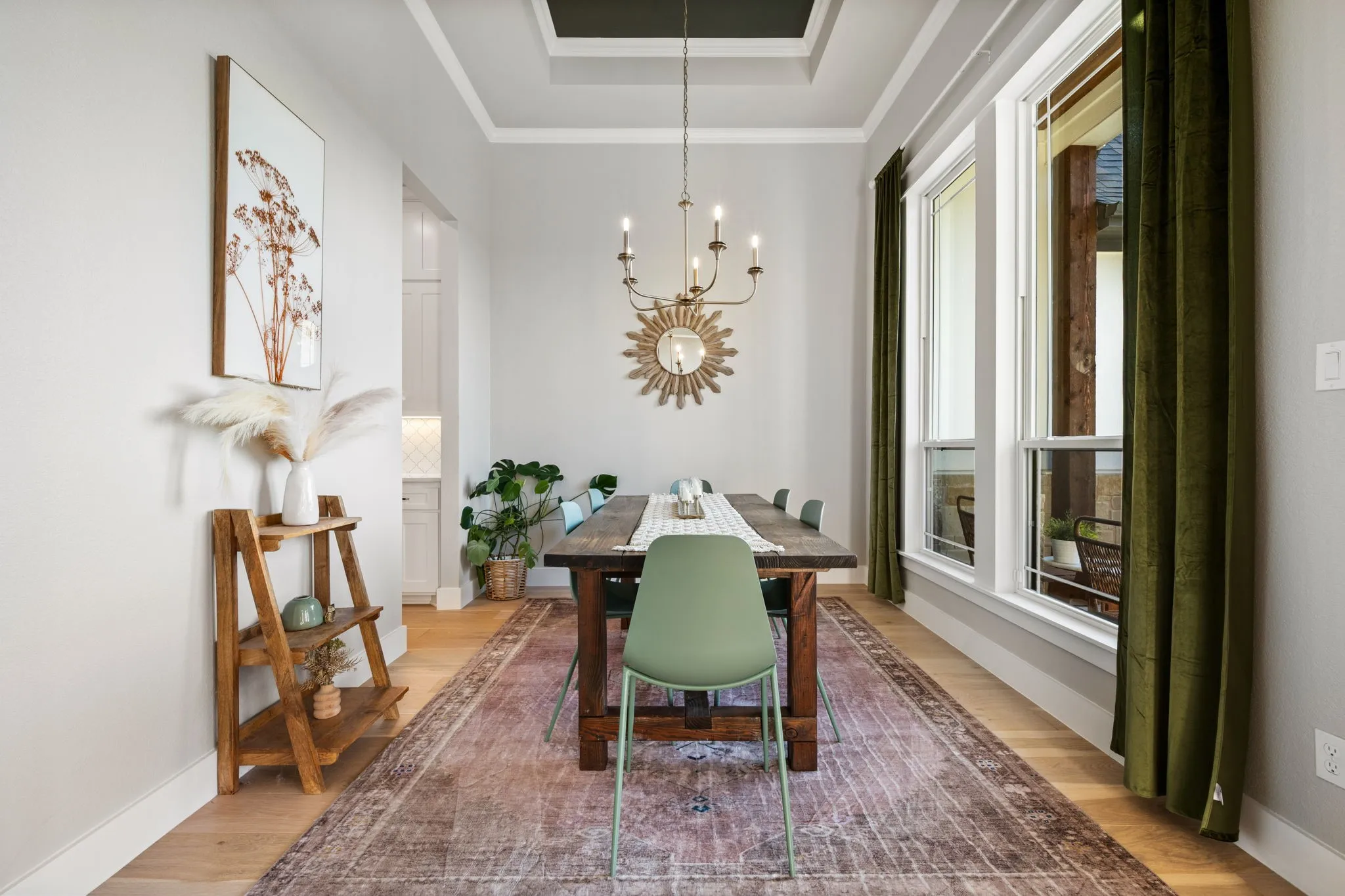 Sophisticated dining room featuring a coffered ceiling with chandelier