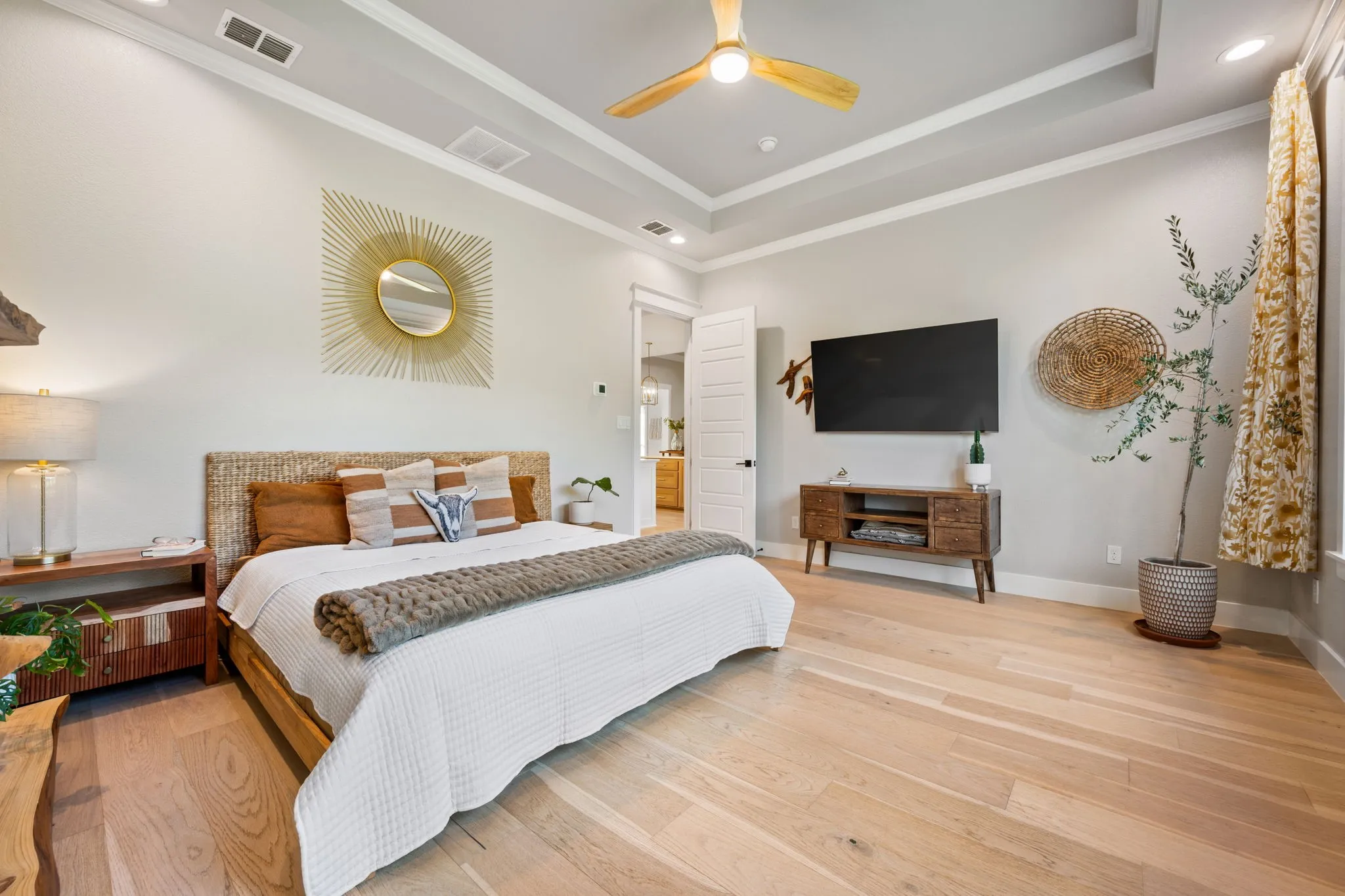 Spacious primary bedroom with ceiling fan