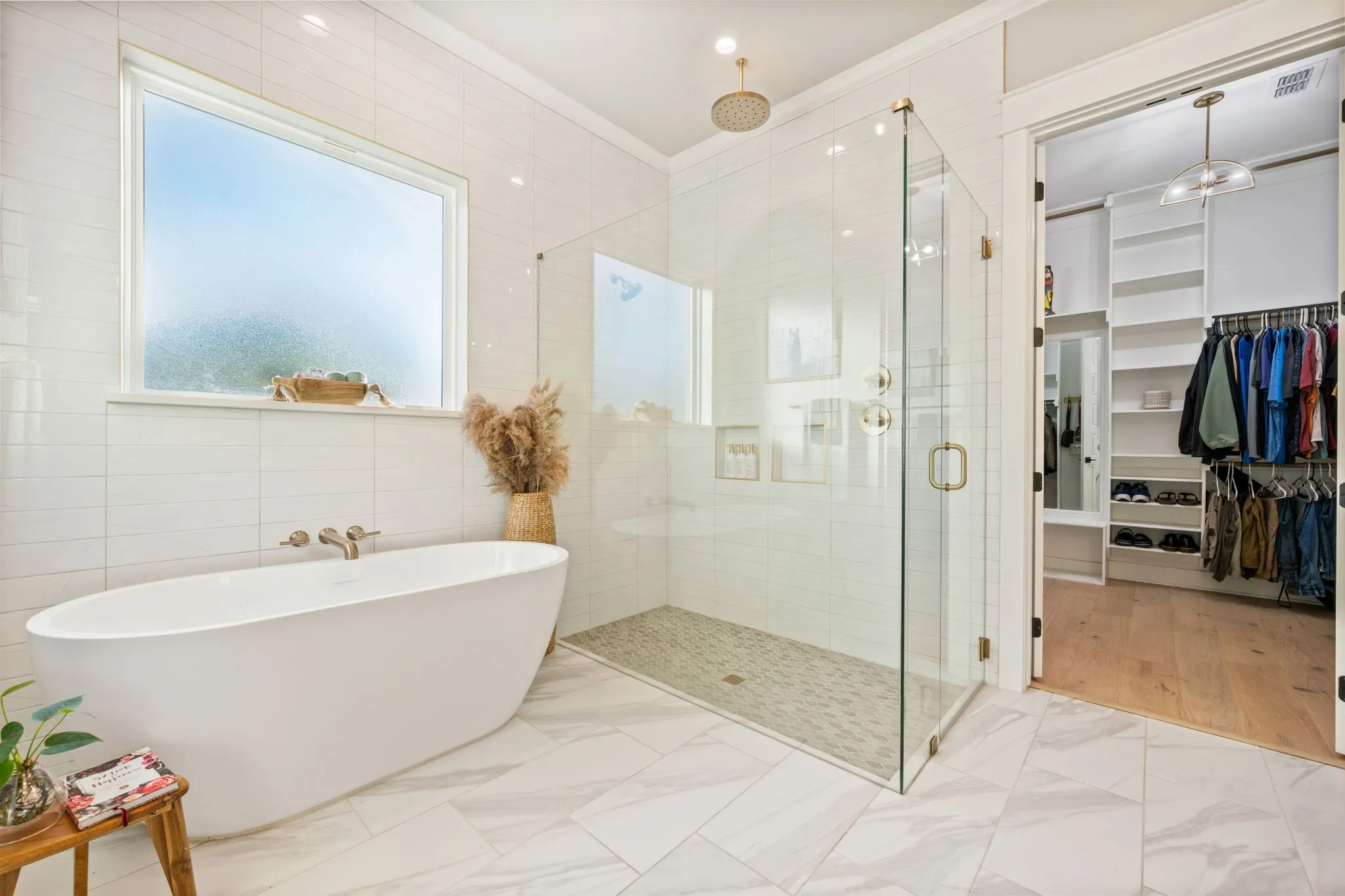 Freestanding soaking tub with wall-mounted fixtures