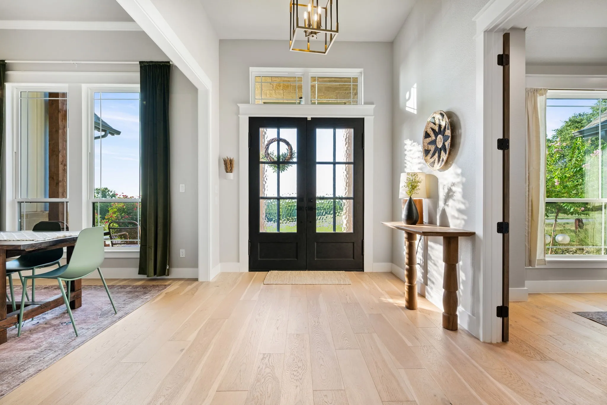 Entry way with iron double doors and transom windows