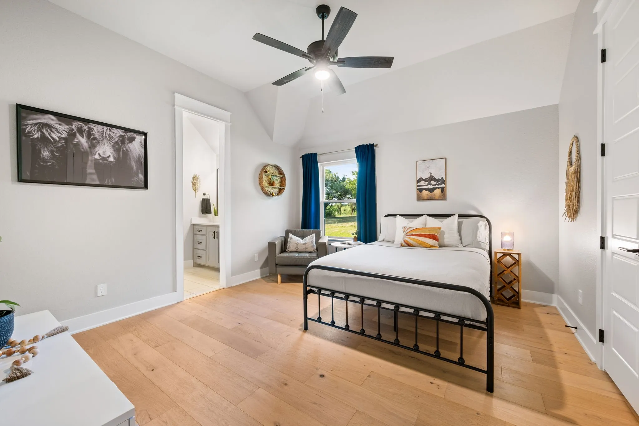 Bedroom featuring a vaulted ceiling with a ceiling fan and walk in closet