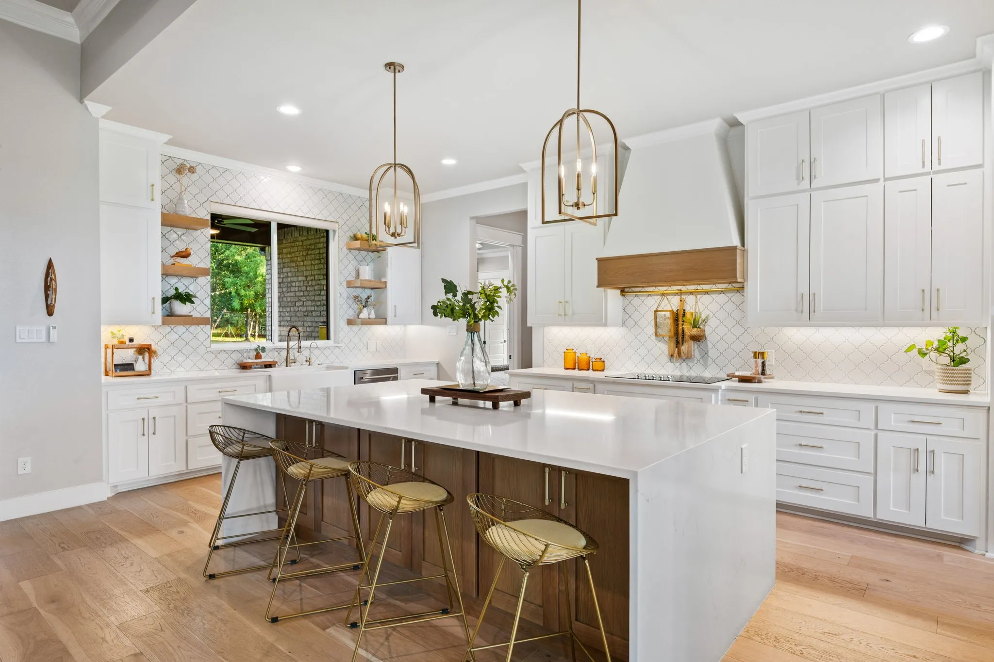 Chef's kitchen featuring white shaker cabinetry, white quartz countertops, and a substantial center island with wood-finish base