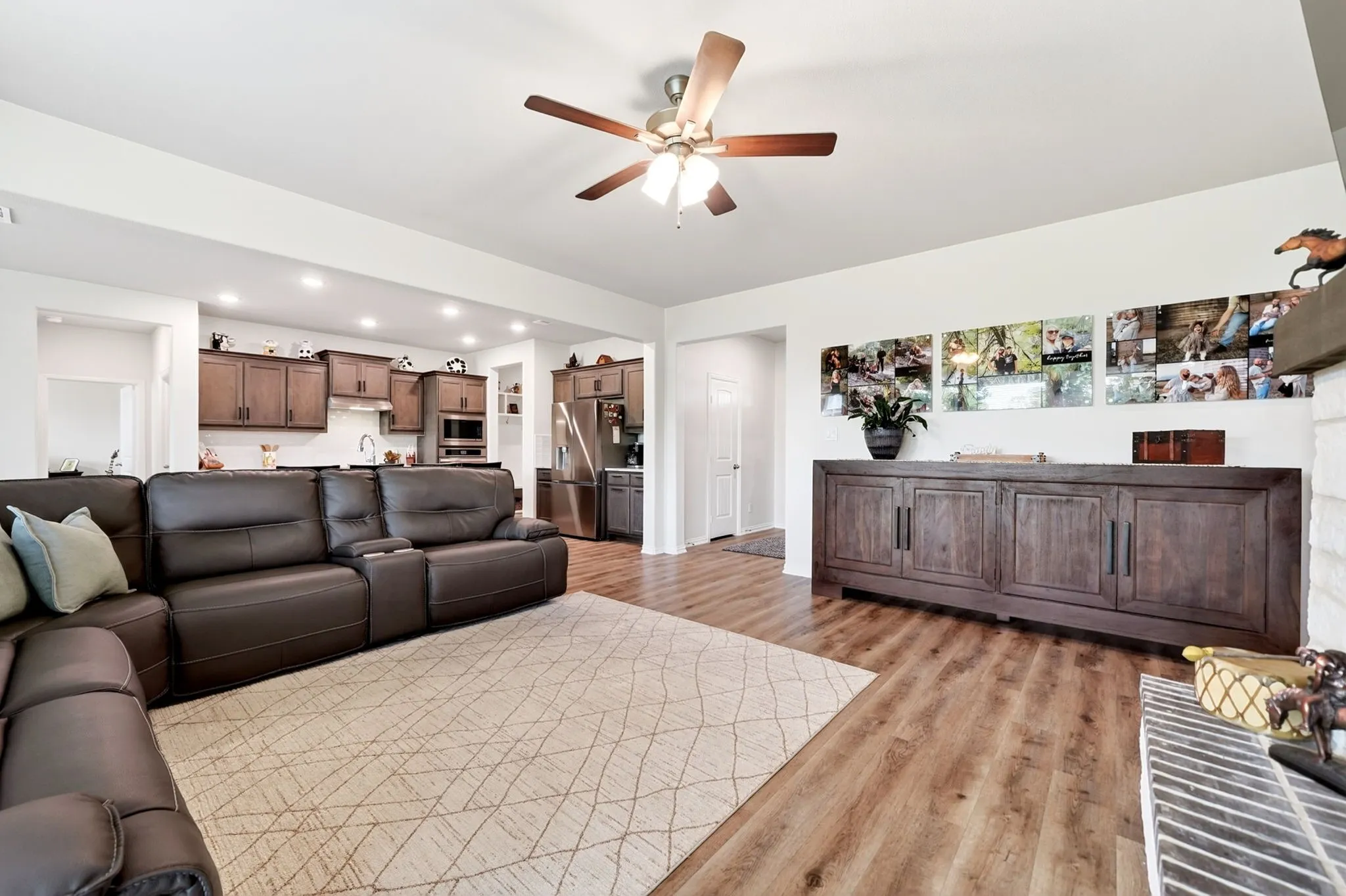 Open-concept living space featuring wood-finish flooring, recessed lighting, and a ceiling fan