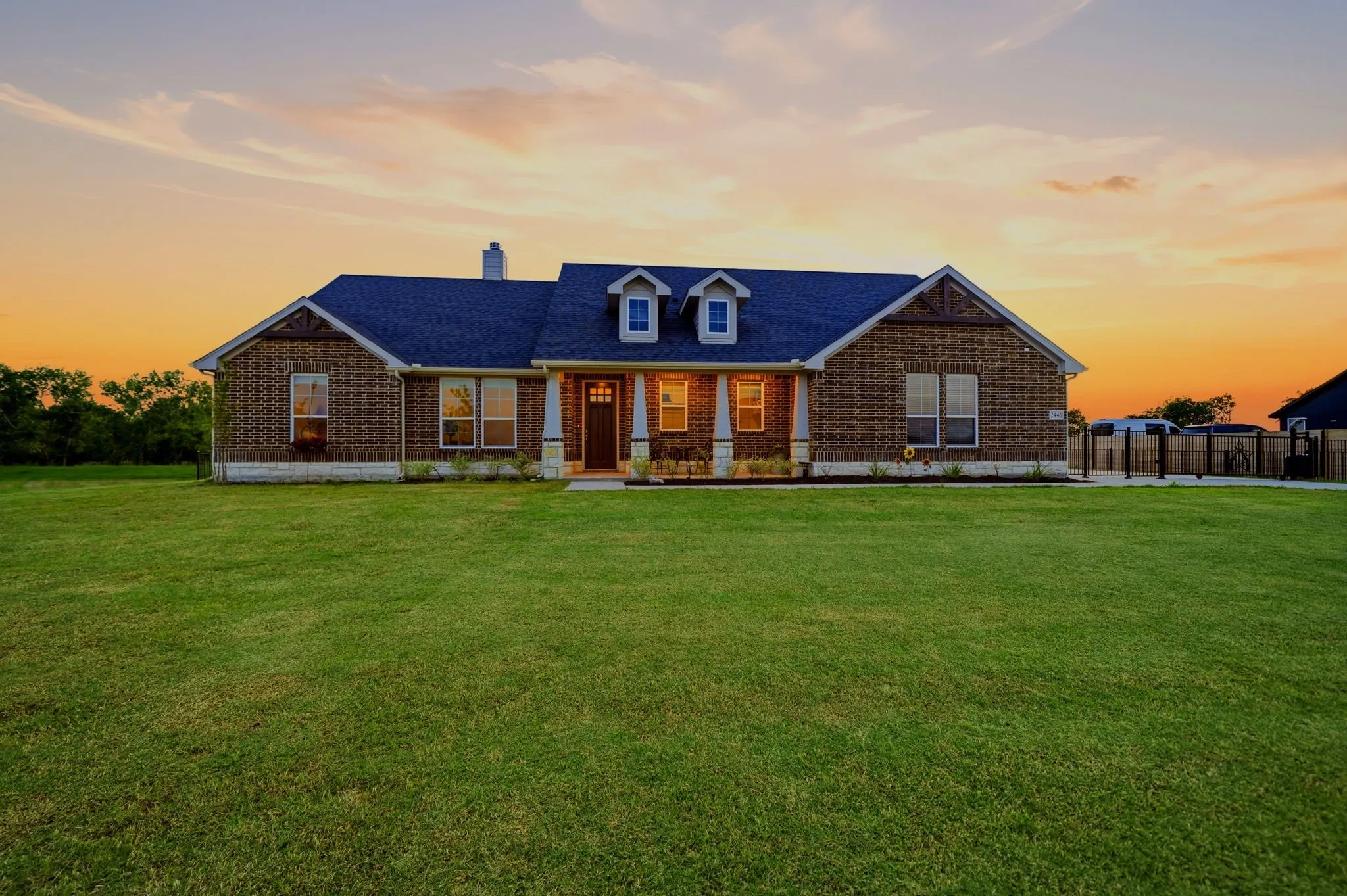 Brick exterior with a dark roof and white trim