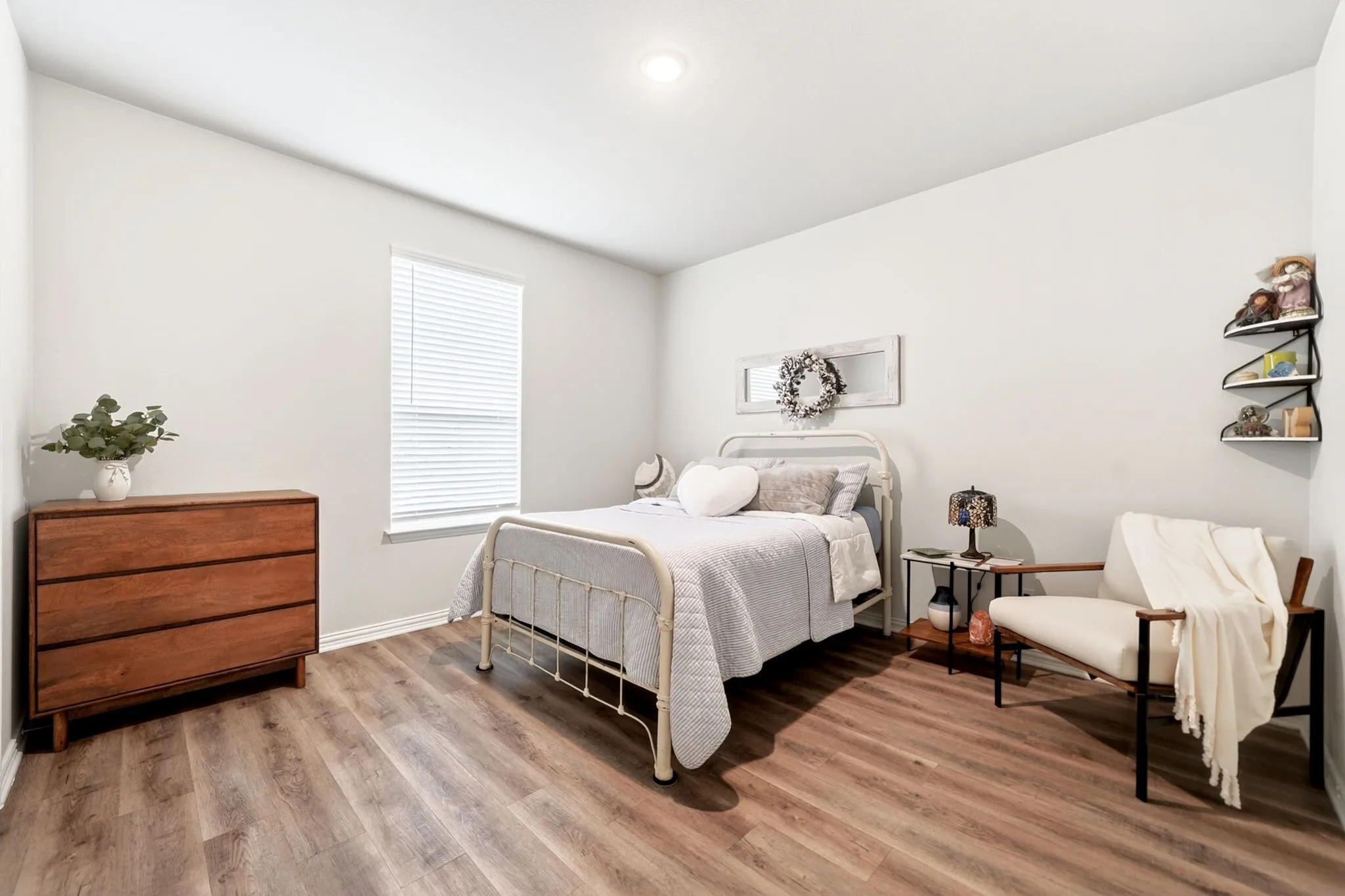 Bedroom featuring wood-finish flooring, a single window with blinds, and recessed lighting