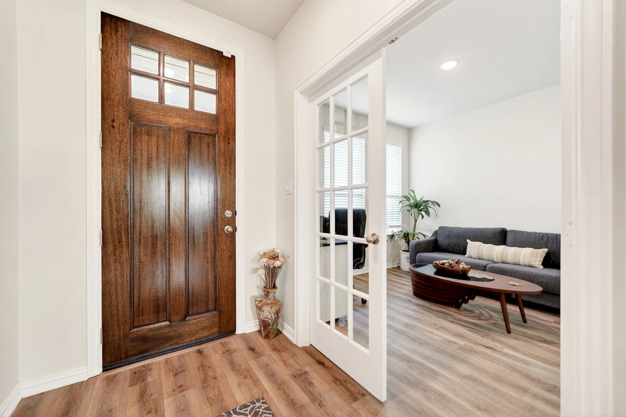 Rich wood-finish entry door with upper window panes
