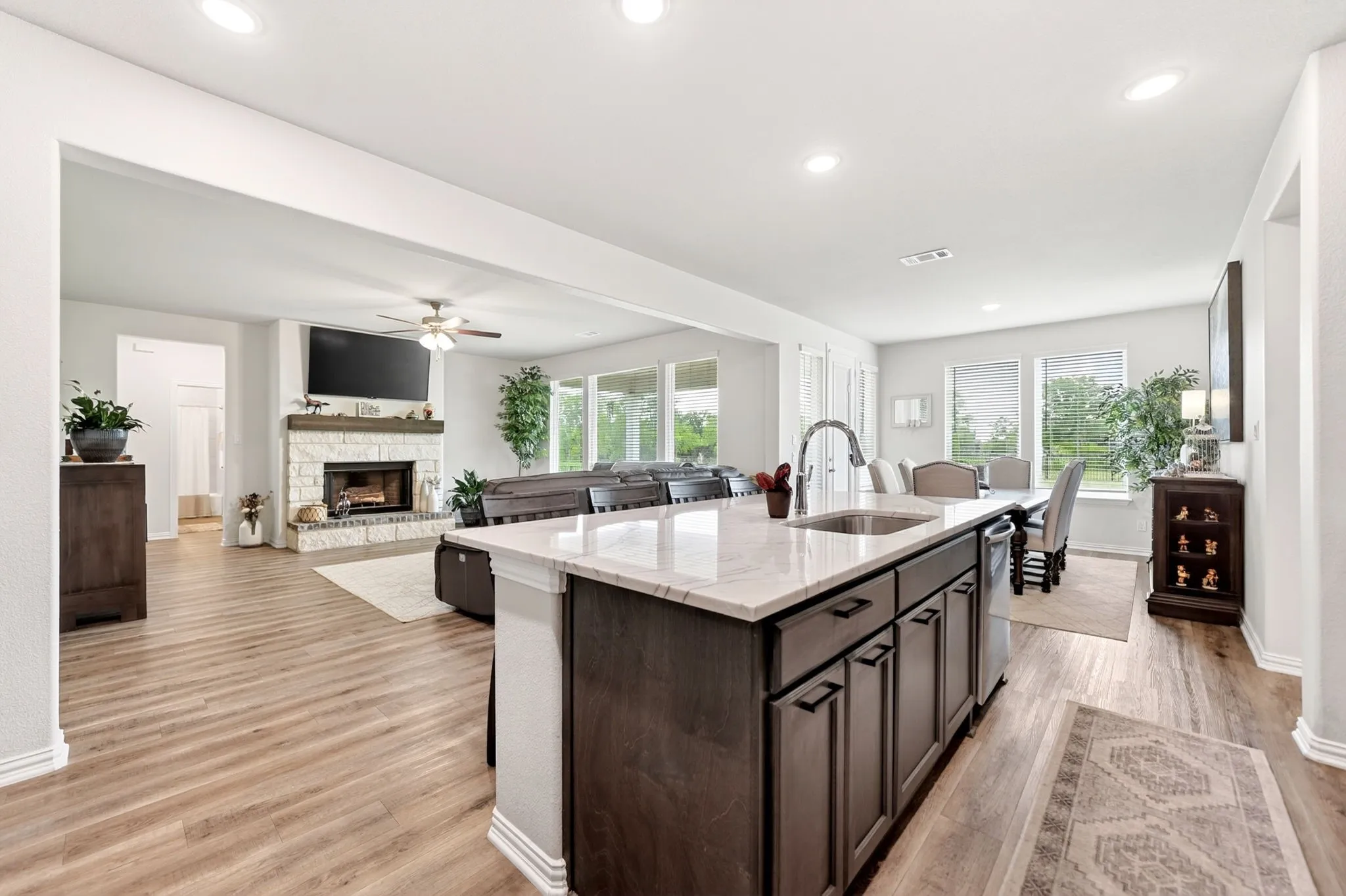 Kitchen island with an undermount sink, gooseneck faucet, and integrated dishwasher
