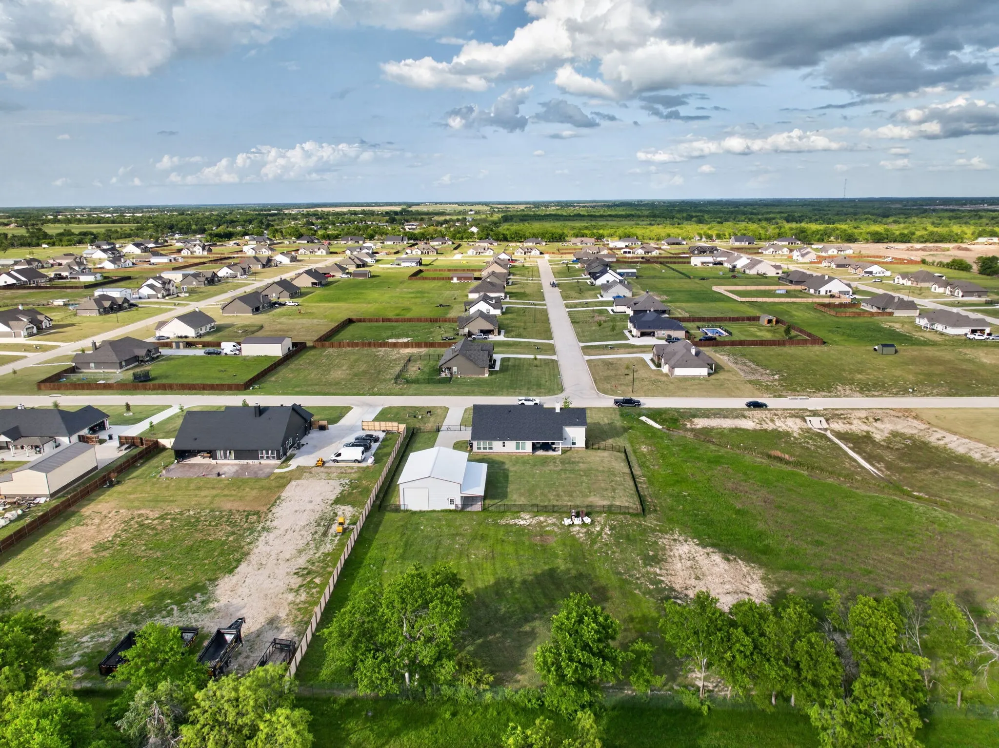 Aerial perspective showcasing a residential community with numerous single-story homes