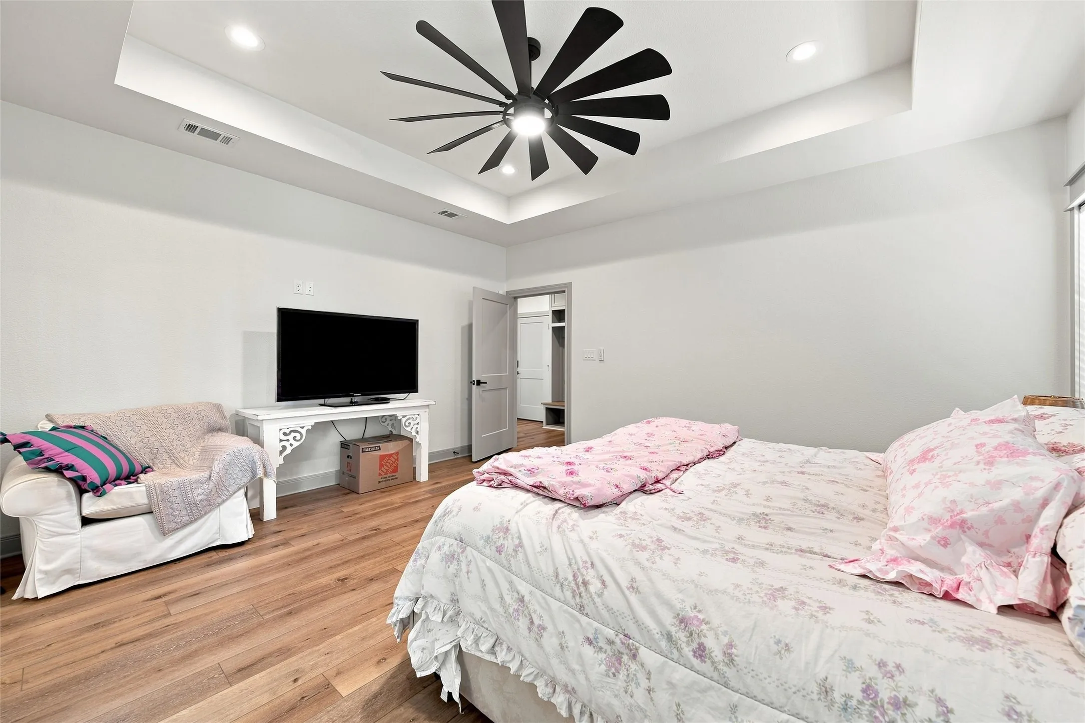 Tray ceiling with recessed lighting and a contemporary ceiling fan