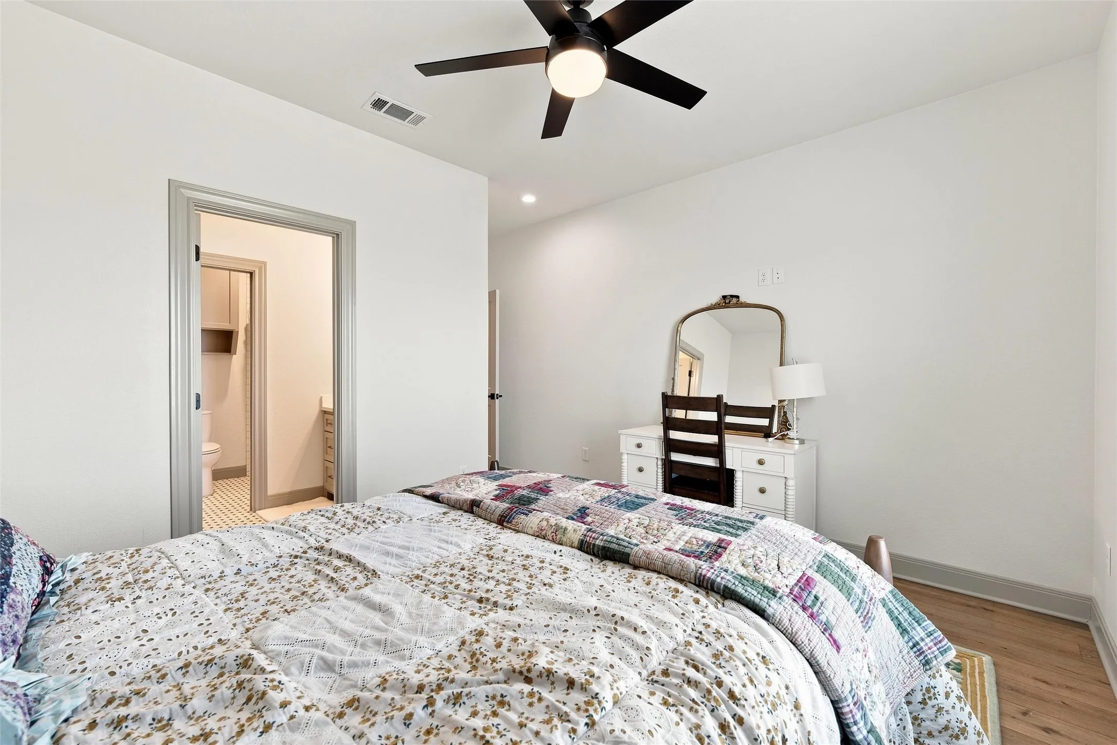 Interior room with light wood-finish flooring and a ceiling fan with integrated lighting