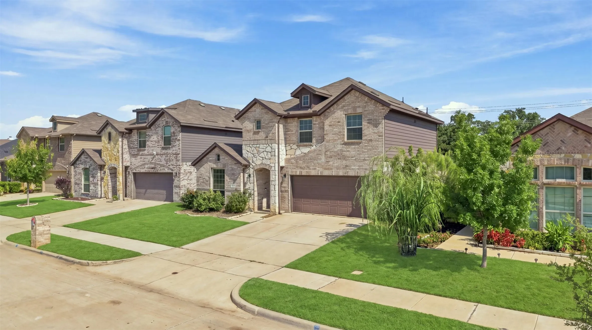 Stone and siding exterior with a dark brown garage door