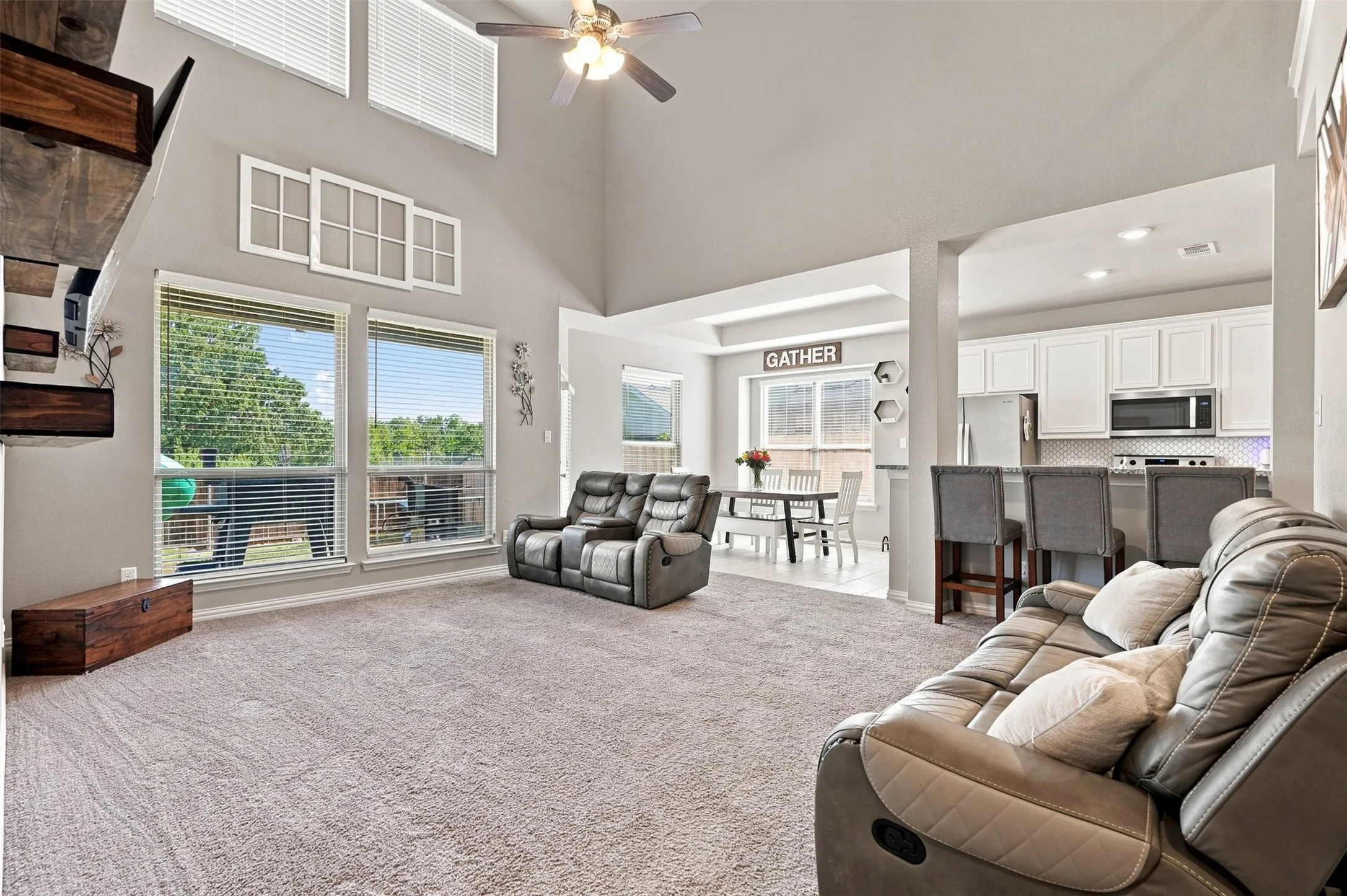 Spacious living area featuring a vaulted ceiling and an open-concept design