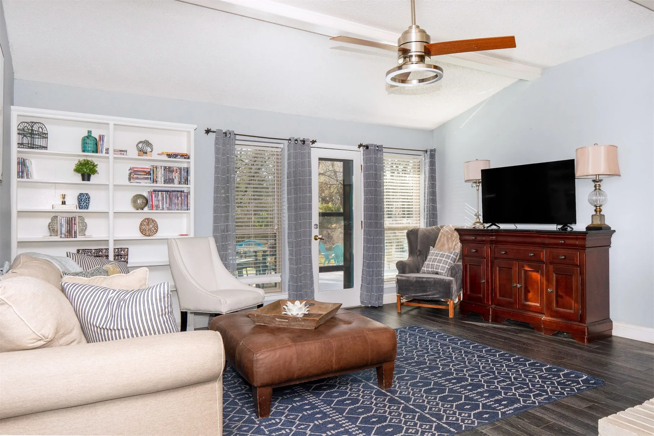 Living area with vaulted ceilings and wood-finish flooring