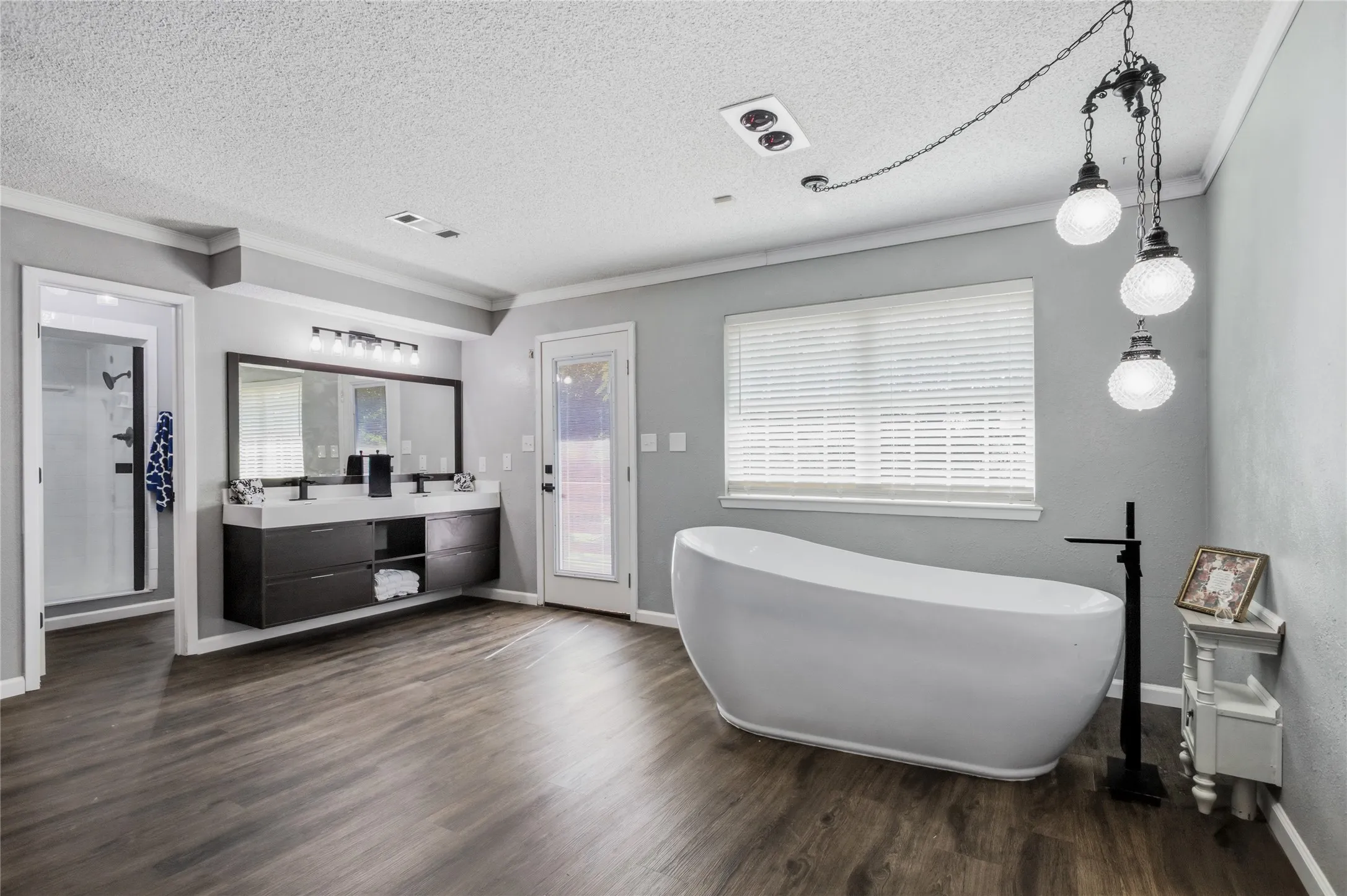 The floating vanity in this area provides 2 more sinks for the bathroom area along with the gorgeous soaking tub.  The door opens out onto a private deck overlooking the private backyard.