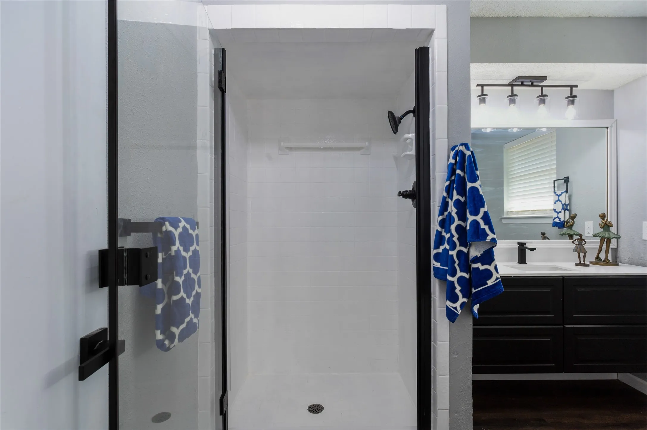 The shower and vanity in the bathroom are set in a private room.