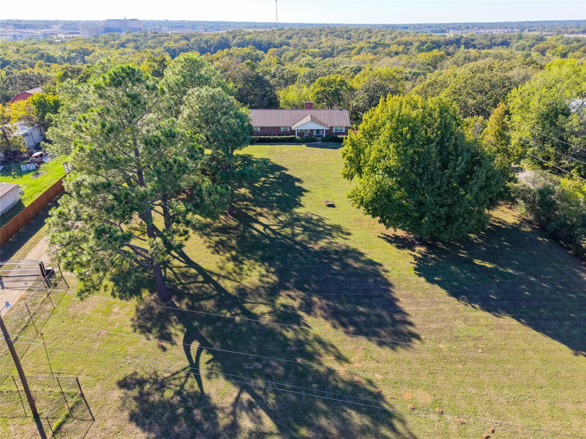 These mature trees seem to embrace this home.  It is truly an experience to step out onto the yard under the gorgeous pines.  You can see the new privacy fence that was added on the left side.