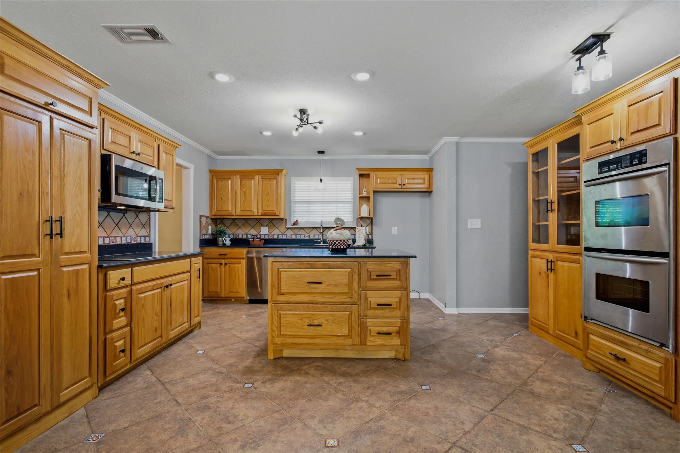 Love cooking?  This kitchen is filled with cabinets, an island, and storage space.  The island has storage on both sides and you can see that it is an easy, open space to work.  The dining room is behind you on this picture and the office is to the left.