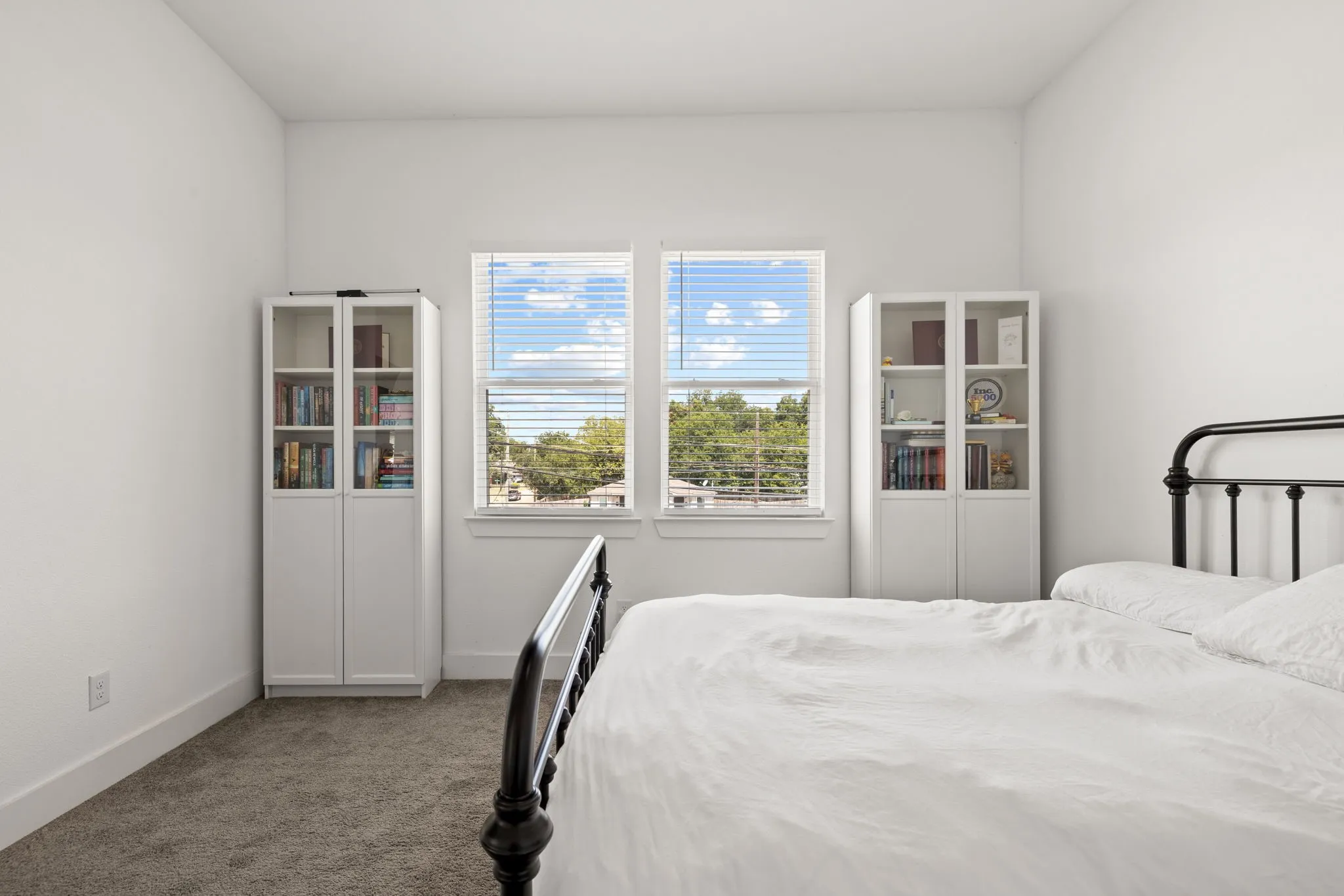 Carpeted room with white walls and baseboards