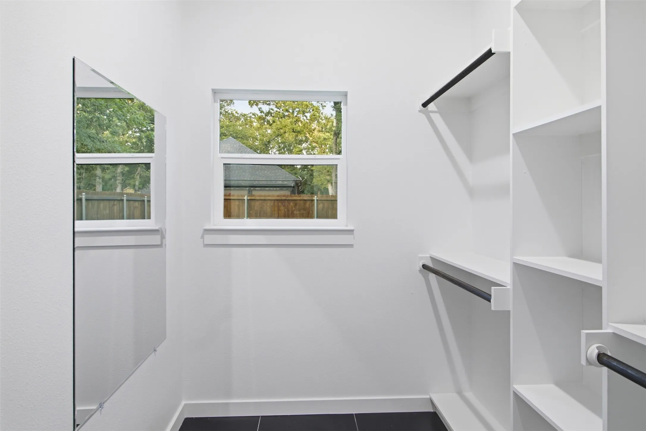 Primary Closet with built in shelves and mirror