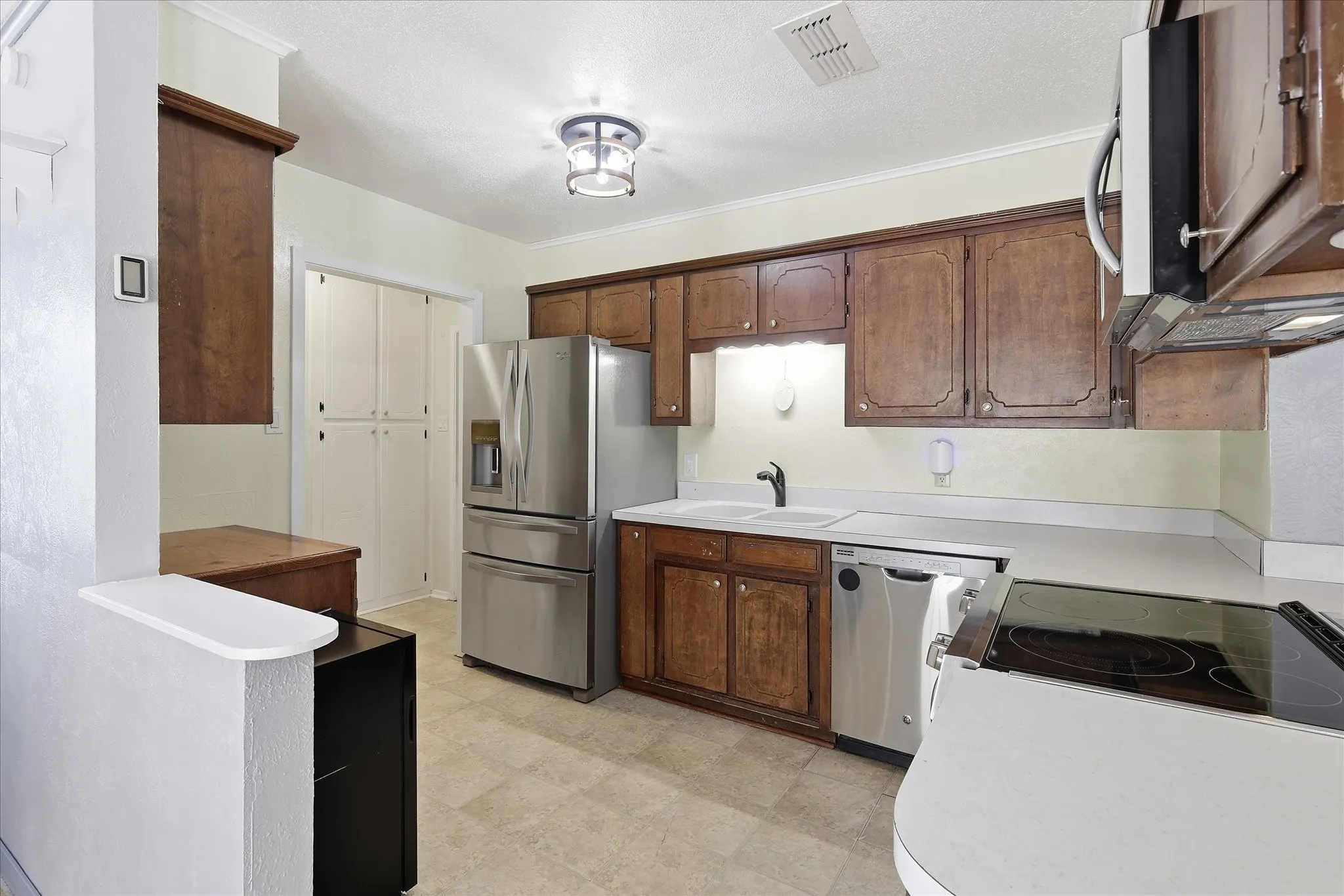 Kitchen offers electric range and microwave.