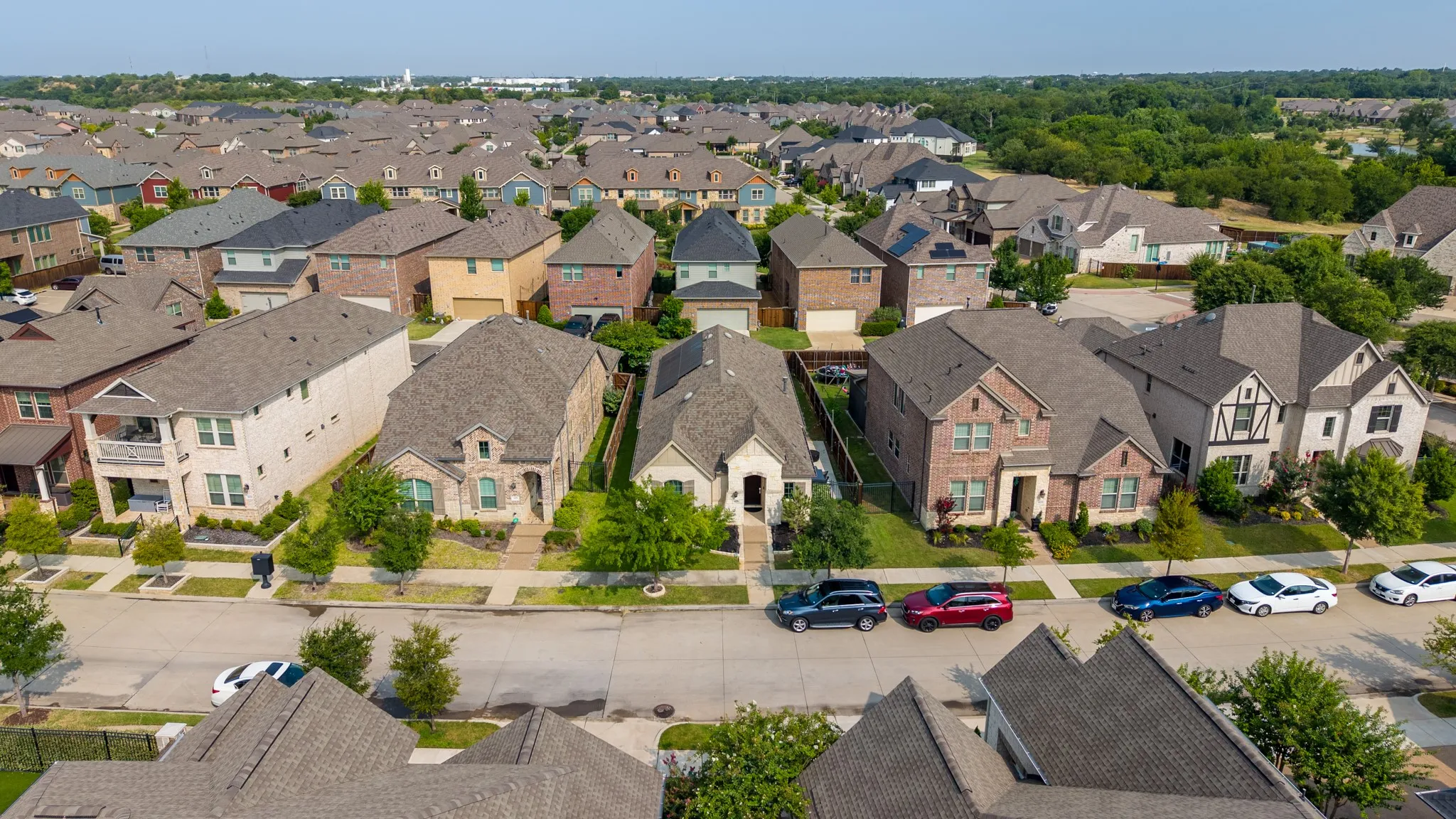 Residential neighborhood featuring a variety of architectural styles, tree-lined streets, and well-maintained landscaping