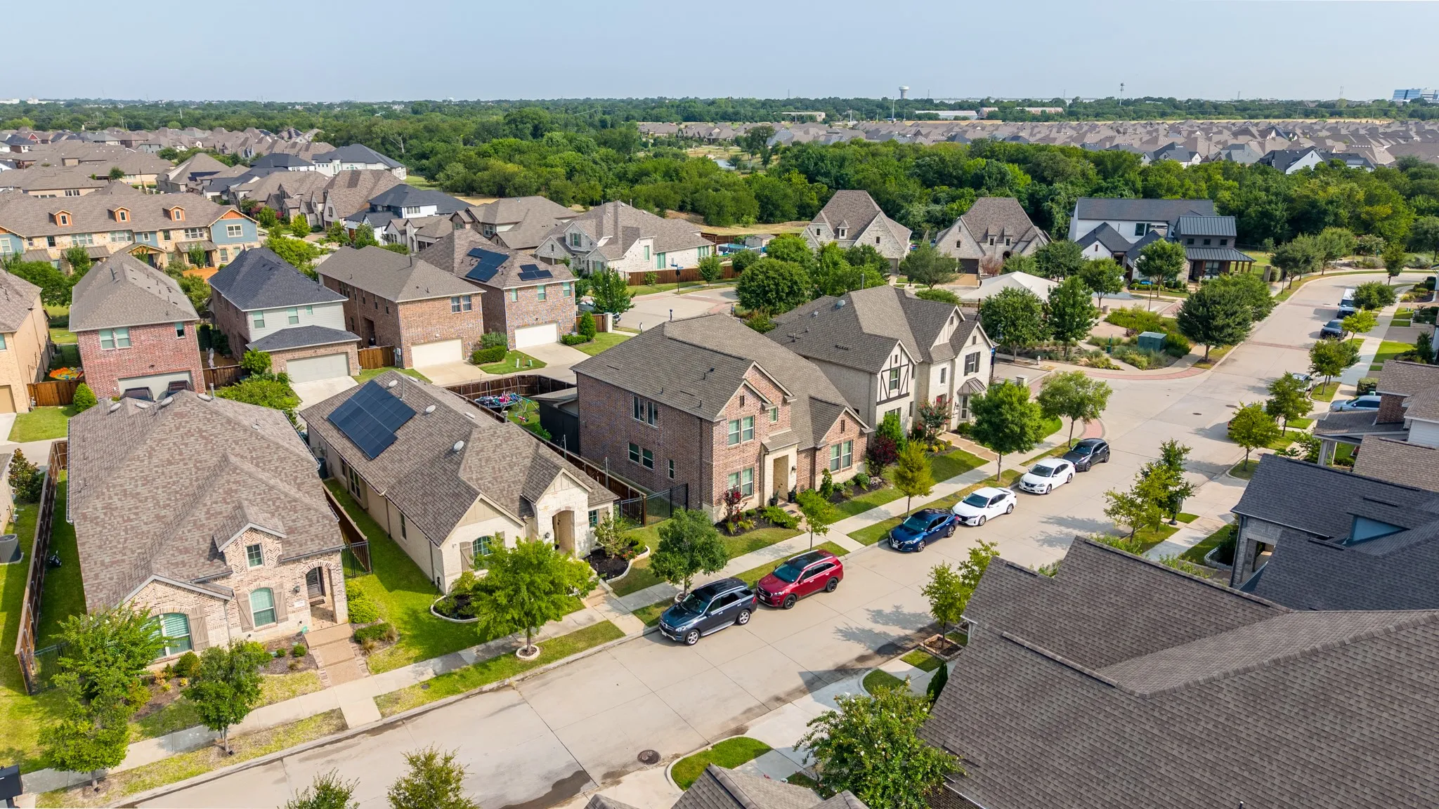 Residential neighborhood featuring a variety of architectural styles, mature landscaping, and tree-lined streets