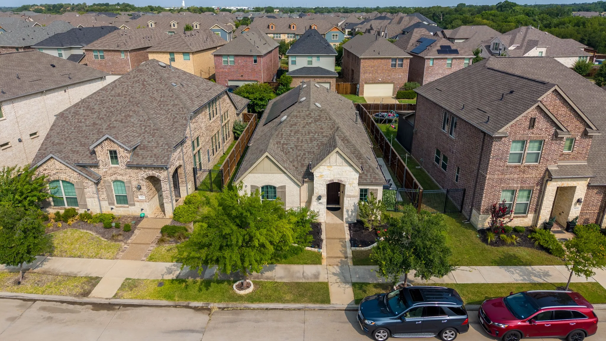 Single-story residence featuring a stone and stucco exterior, an arched entry, and a gabled roof