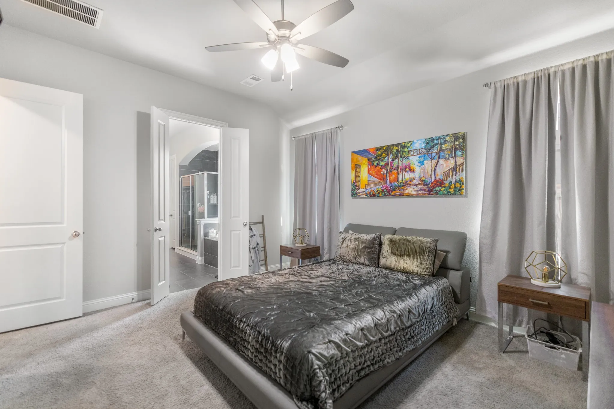 Carpeted bedroom with a ceiling fan, light gray walls, and recessed lighting