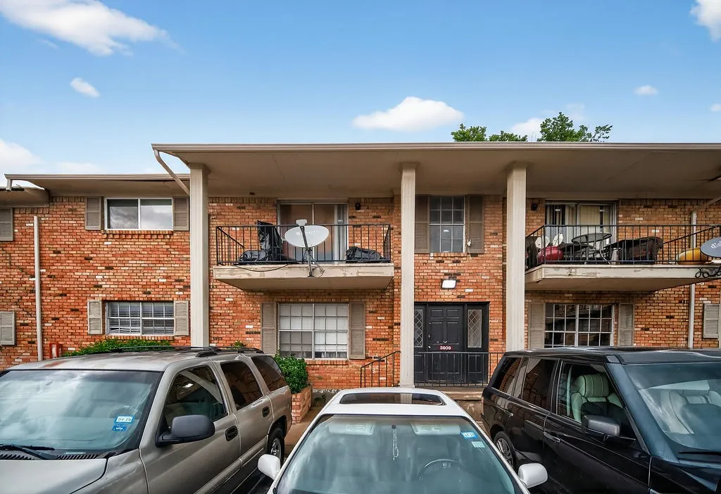 Brick exterior with balconies and ground-level patios