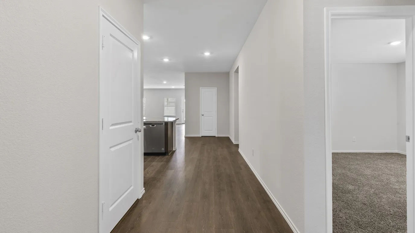 Hallway featuring wood-finish flooring, recessed lighting, and neutral wall tones
