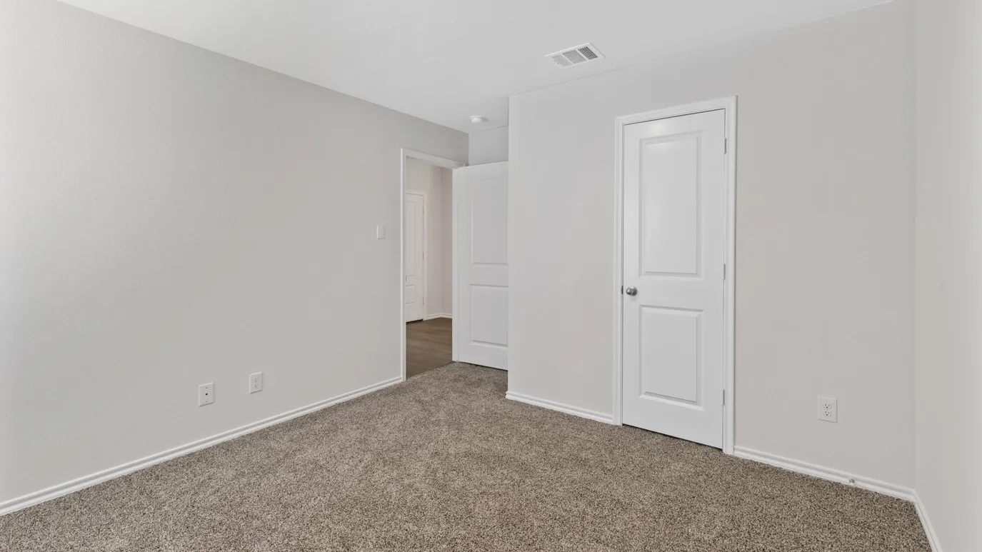 Carpeted room with light neutral walls and white trim